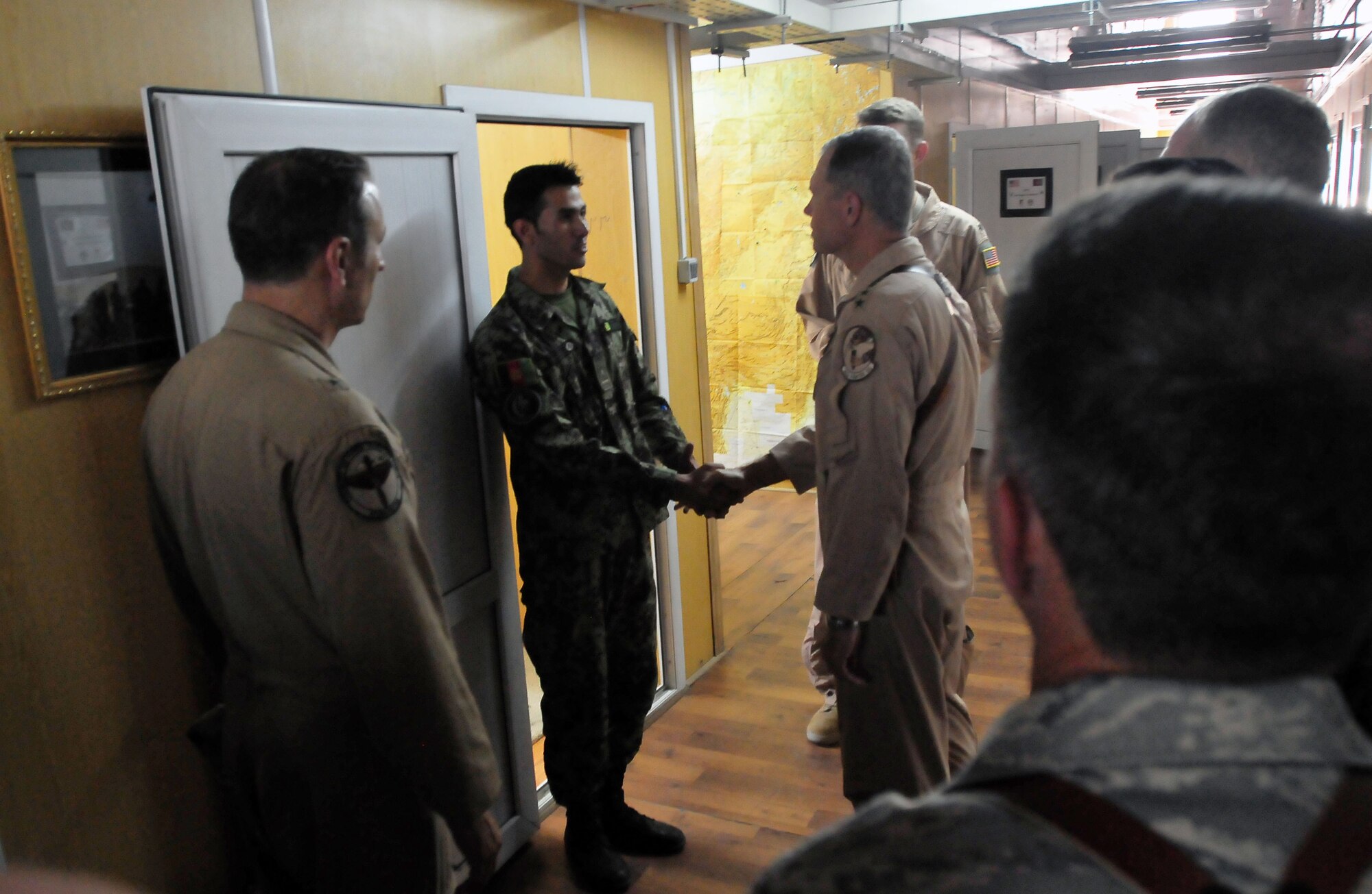 100723-N-6031Q-004 KABUL, Afghanistan - Gen. William M. Fraser III, Commander of the Air Combat Command, center, visited the Afghan Air Force Base in Kabul on July 23, 2010. Fraser, along with Lt. Gen. Michael Hostage, U.S. Air Forces Central commander, toured the "Thunder Lab", an English immersion program for Afghan pilot candidates. Fraser also toured the living quarters and demonstrated his own pilot skills on the Rotary Wing flight simulator. The visit gave Fraser the opportunity to meet various service members working with the Combined Air Power Transition Force as well as Gen. Darwan, Commanding General of the Afghan Air Force. (US Navy photo by Mass Communication Specialist 2nd Class David Quillen/ RELEASED).