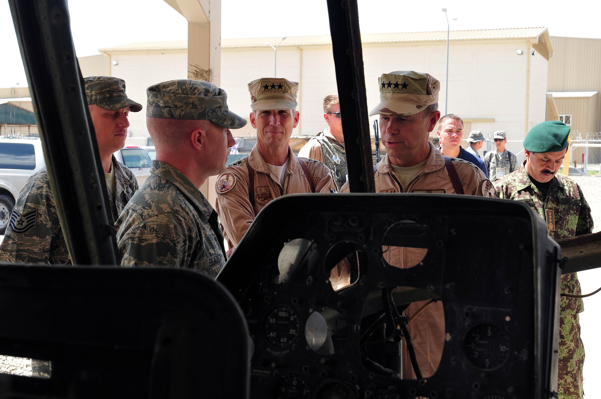 100723-N-6031Q-003 KABUL, Afghanistan - Gen. William M. Fraser III, Commander of the Air Combat Command, right, is briefed on the condition of the flight simulator when he visited the Afghan Air Force Base in Kabul on July 23, 2010. Fraser, along with Lt. Gen. Michael Hostage, U.S. Air Forces Central commander, toured the "Thunder Lab", an English immersion program for Afghan pilot candidates. Fraser also toured the living quarters and demonstrated his own pilot skills on the Rotary Wing flight simulator. The visit gave Fraser the opportunity to meet various service members working with the Combined Air Power Transition Force as well as Gen. Darwan, Commanding General of the Afghan Air Force. (US Navy photo by Mass Communication Specialist 2nd Class David Quillen/ RELEASED).