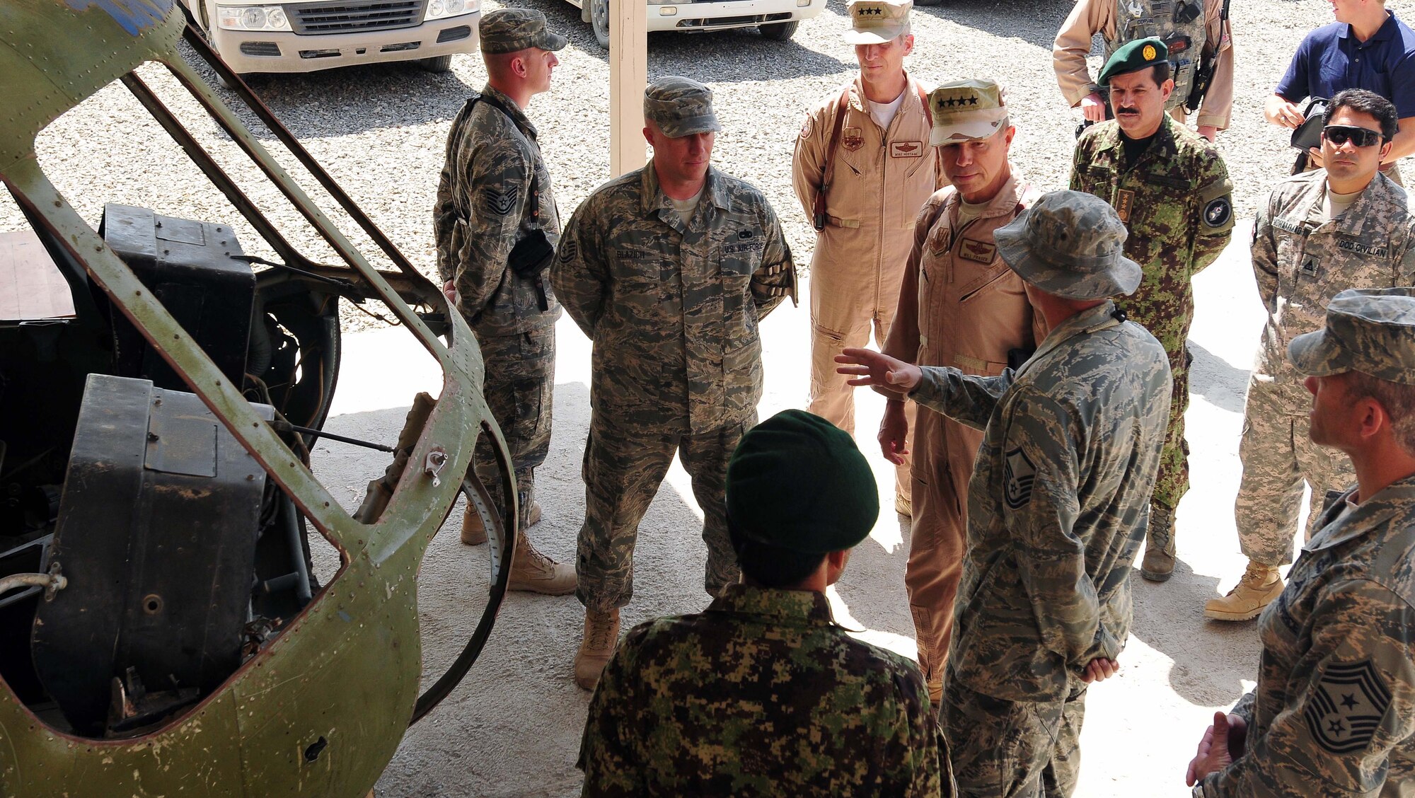 100723-N-6031Q-002 KABUL, Afghanistan - Gen. William M. Fraser III, Commander of the Air Combat Command, center, is briefed on the condition of the flight simulator when he visited the Afghan Air Force Base in Kabul on July 23, 2010. Fraser, along with Lt. Gen. Michael Hostage, U.S. Air Forces Central commander, toured the "Thunder Lab", an English immersion program for Afghan pilot candidates. Fraser also toured the living quarters and demonstrated his own pilot skills on the Rotary Wing flight simulator. The visit gave Fraser the opportunity to meet various service members working with the Combined Air Power Transition Force as well as Gen. Darwan, Commanding General of the Afghan Air Force. (US Navy photo by Mass Communication Specialist 2nd Class David Quillen/ RELEASED).