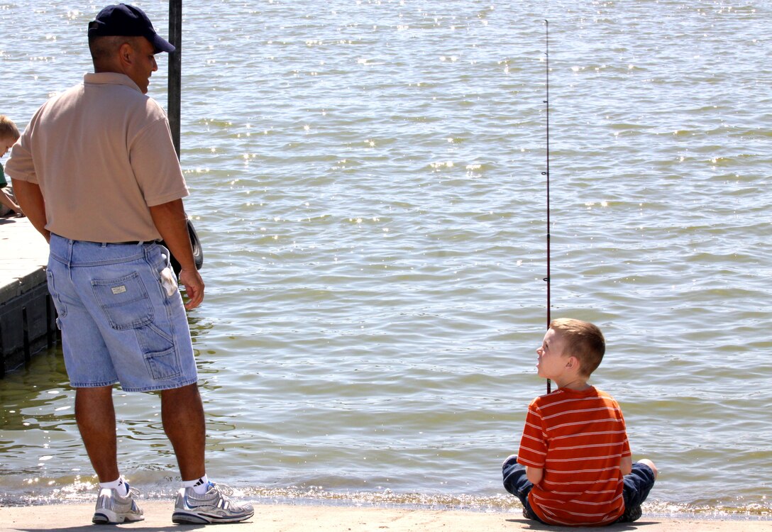 Gustavo Cano (left) gives his “little brother,” Russel Jewell, advice on how to catch the big one, during Big Brothers Big Sisters of San Diego County’s third annual “Operation Field Day” at Camp Pendleton’s Lake O’Neill, June 25. In addition to fishing, children, their families and mentors participated in activities such as paddle boating, miniature golf, horseshoes, and barbecue.