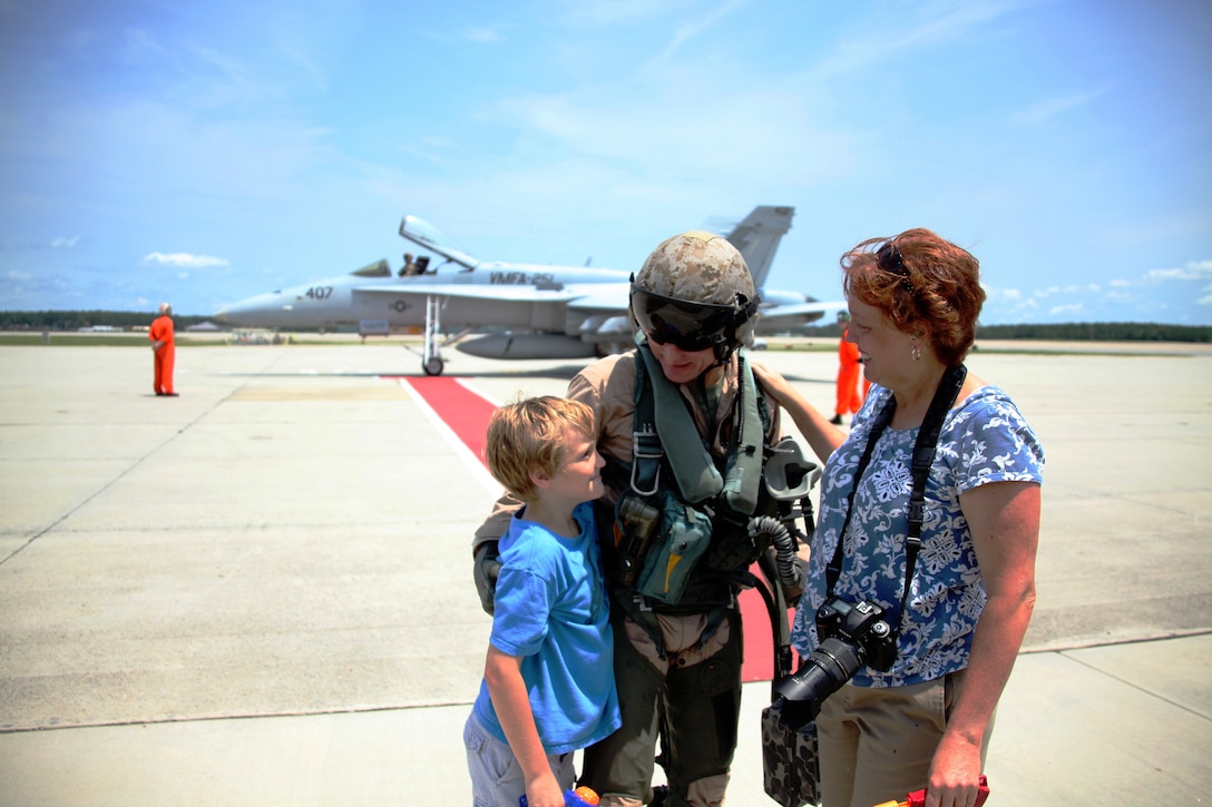 Major General James F. Flock is greeted by his wife Kelly and son Jack on the Cherry Point flight line after taking his last flight in the AV-8B Harrier, July 26. Flock was the commanding general of 2nd Marine Aircraft Wing from Oct. 2008 to July 2010. Flock is retiring after 35 years of active service.