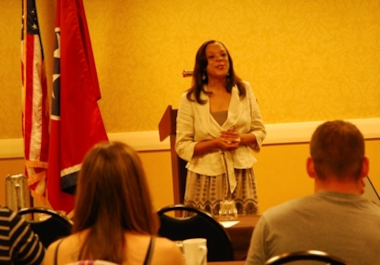 Tech. Sgt. Cynthia Owens, Dobbins’ Yellow Ribbon program manager, welcomes servicemembers and their families to a Yellow Ribbon Reintegration Program, July 23-25.  (U.S. Air Force photo/J.D. Marckmann)