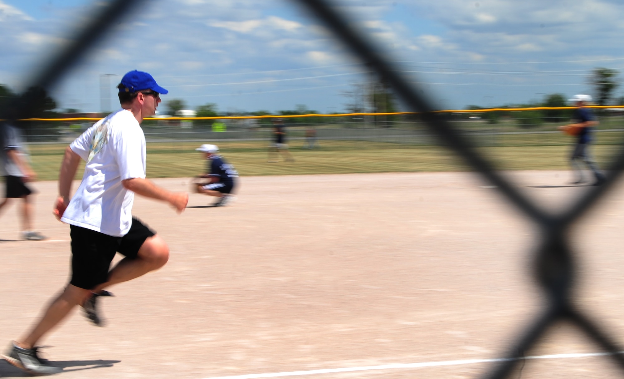 ELLSWORTH AIR FORCE BASE, S.D. -- Col. Jeffrey Taliaferro, 28th Bomb Wing commander, dashes to first base during the annual Chiefs vs. Eagles softball game, July 23.  The commander hit a home-run scoring one point for the Eagles team. (U.S. Air Force photo/Airman 1st Class Anthony Sanchelli)