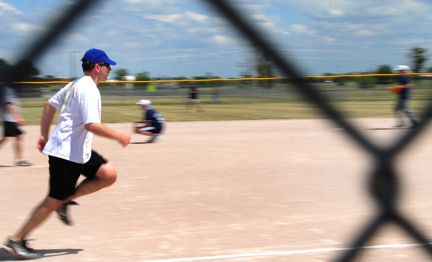 ELLSWORTH AIR FORCE BASE, S.D. -- Col. Jeffrey Taliaferro, 28th Bomb Wing commander, dashes to first base during the annual Chiefs vs. Eagles softball game, July 23.  The commander hit a home-run scoring one point for the Eagles team. (U.S. Air Force photo/Airman 1st Class Anthony Sanchelli)
