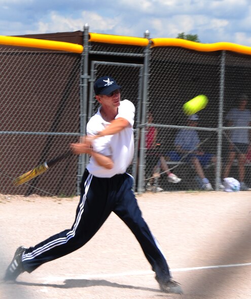 ELLSWORTH AIR FORCE BASE, S.D. -- Chief Master Sgt. (Ret.) Carl Engwall, 28th Bomb Wing Air and Space Museum director, swings at a softball during the annual Chiefs vs. Eagles game, July 23.  Chief Engwall plays for the Chief's team as their primary pitcher during the game. (U.S. Air Force photo/Airman 1st Class Anthony Sanchelli)