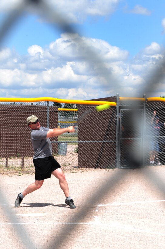 ELLSWORTH AIR FORCE BASE, S.D. -- Lt. Col. Dwain Slaughter, 28th Maintenance Group deputy commander, strikes a softball during the annual Chiefs vs. Eagles game, July 23.  Lt. Col. Slaughter played for the Eagle's team. (U.S. Air Force photo/Airman 1st Class Anthony Sanchelli)