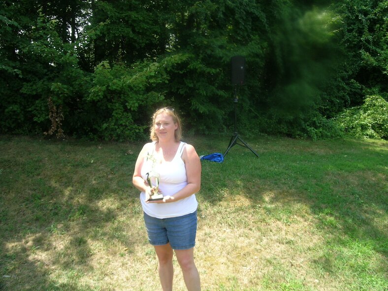 Missy Koehler, spouse of Technical Sgt. Wade Koehler AFDW Safety, shows off the first place trophy she won for her recipe Buffalo Chicken Dip in the best dish contest during the AFDW Family Day Picnic held July 23, 2010, at Freedom Park, Andrews AFB, Md.  (U.S. Air Force photo by Aletha Frost, AFDW/PA)