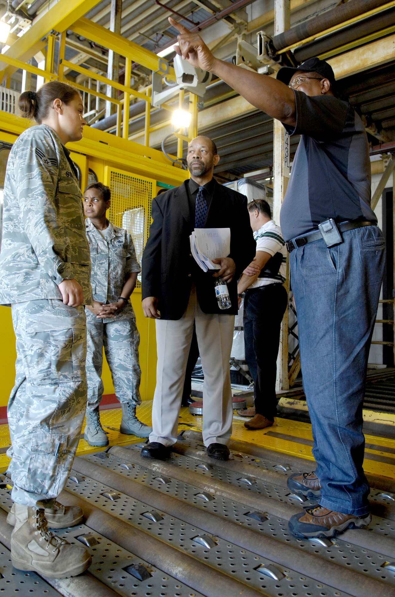 Bobby Robinson guides a group of scientists and engineers from the Air Force Research Laboratory through the 437th Aerial Port Squadron July 16, 2010 at Joint Base Charleston, S.C. The researchers visited JB Charleston's to look for potential improvements that could be made to increase efficiency via robotics.  Mr. Robinson is an air freight supervisor with the 437th APS. (U.S. Air Force photo/Airman 1st Class Lauren Main)