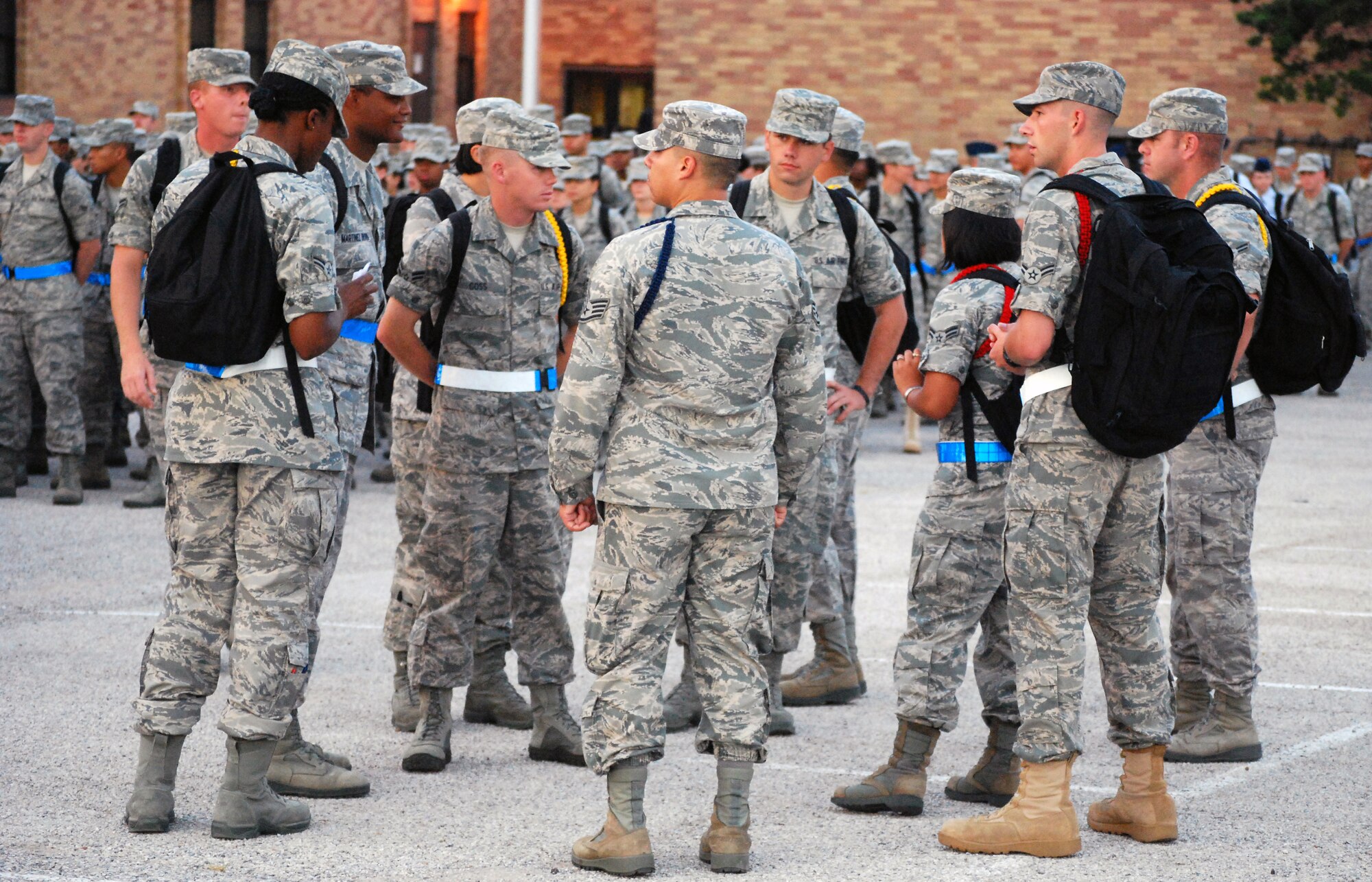 Airman leaders receive last minute instructions from Staff Sgt. Miguel Hernandez, 882 Training Group military training leader, in the parking lot of Bldg. 596 July 23 before moving their sections of the 882nd TRG formation at Sheppard Air Force Base, Texas.  Airman leaders wear colored ropes to distinguish their leadership roles during technical training.  From lowest to highest authority, the order is green, yellow and red ropes.  (U.S. Air Force photo/Tech. Sgt. Vernon Cunningham)