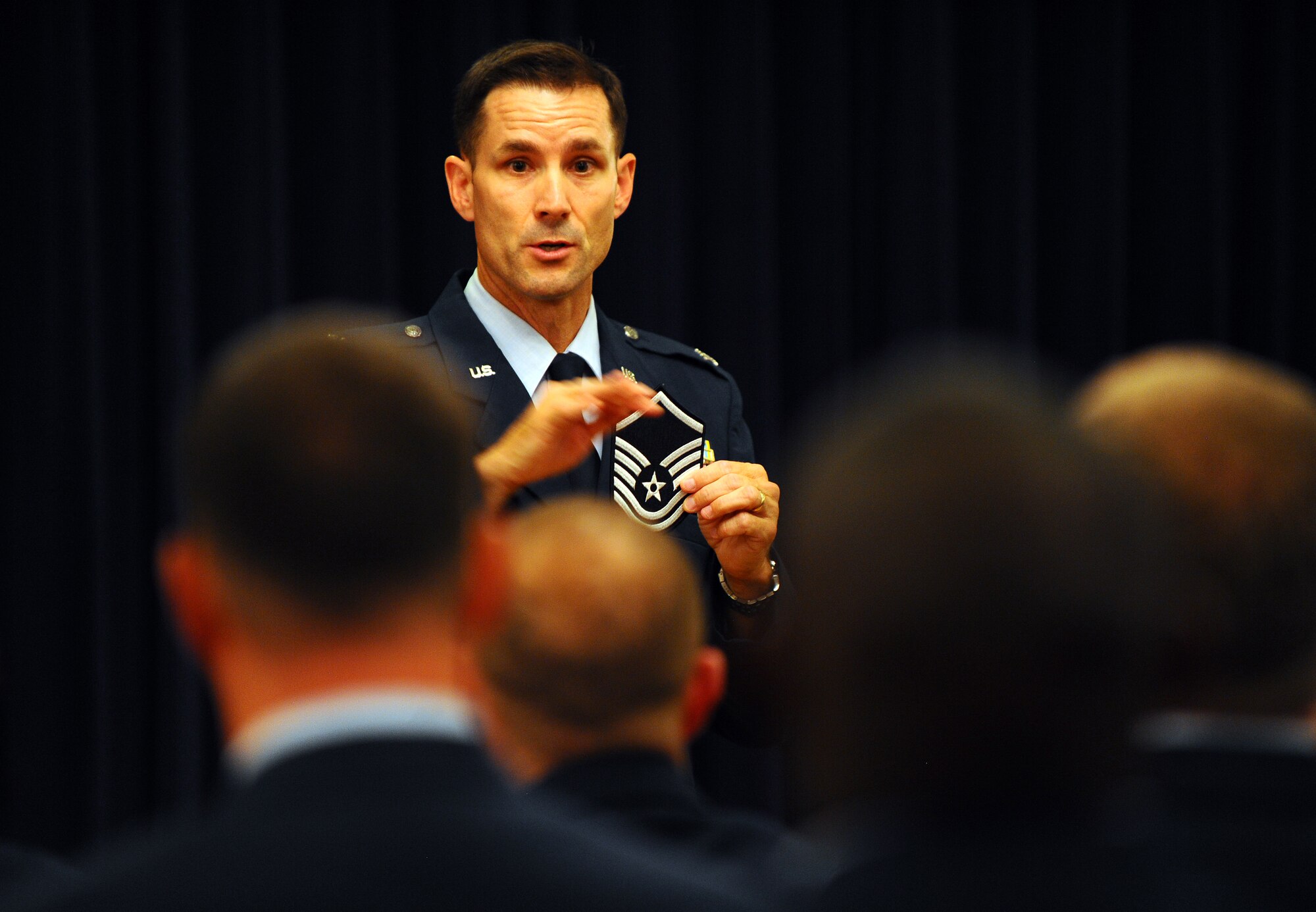 OFFUTT AIR FORCE BASE, Neb. - Col. William P. Jensen, 55th Wing vice commander, provides closing remarks as the guest speaker at the Senior Noncommissioned Officer Induction Ceremony at the Patriot Club July 23. SNCO inductees donned red cloths on their right shoulders as a throw-back to the Continental Army where sergeants where distinguished from privates, corporals or musicians with an epaulette or strip of red cloth sewn onto the right shoulder. U.S. Air Force photo by Josh Plueger
