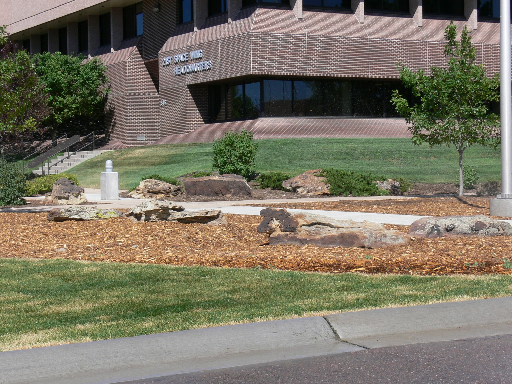 The Peterson Air Force Base Facilities Excellence Program calls for incorporating xeriscape initiatives into the base landscape design, such as the new pedestrian area outside of the 21st Space Wing headquarters building. A team of facilities experts from Air Force Space Command visited Peterson in June to review its facilities program, which includes its use of sustainable energy designs. (U.S. Air Force photo/Monica Mendoza)