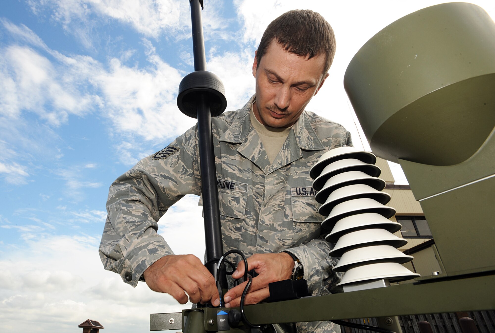 Staff Sgt. Charles Malone readies a surveying instrument as part of the Tactical Meteorological Observing System station, July 6, 2010, at Whiteman Air Force Base, Mo. The TMOS systems can be set up and sending data within 15 minutes. Sergeant Malone is a 509th Operation Support Squadron weather forecaster. (U.S. Air Force photo/Senior Airman Carlin Leslie)