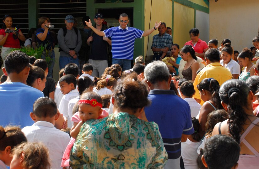 EL ROBLITO, Honduras -- As the citizens of this mountain village bow their heads, Chaplain (Capt.) Eric Miletti, from Joint Task Force-Bravo, prays over them during the Chapel Hike here July 16. The Soto Cano Air Base Friendship Chapel sponsors monthly hiking trips that partners Joint Task Force-Bravo members with local community leaders, city hall officials and the World Food Program to provide support to surrounding villages in need of food and supplies. (U.S. Air Force photo/Tech. Sgt. Benjamin Rojek)