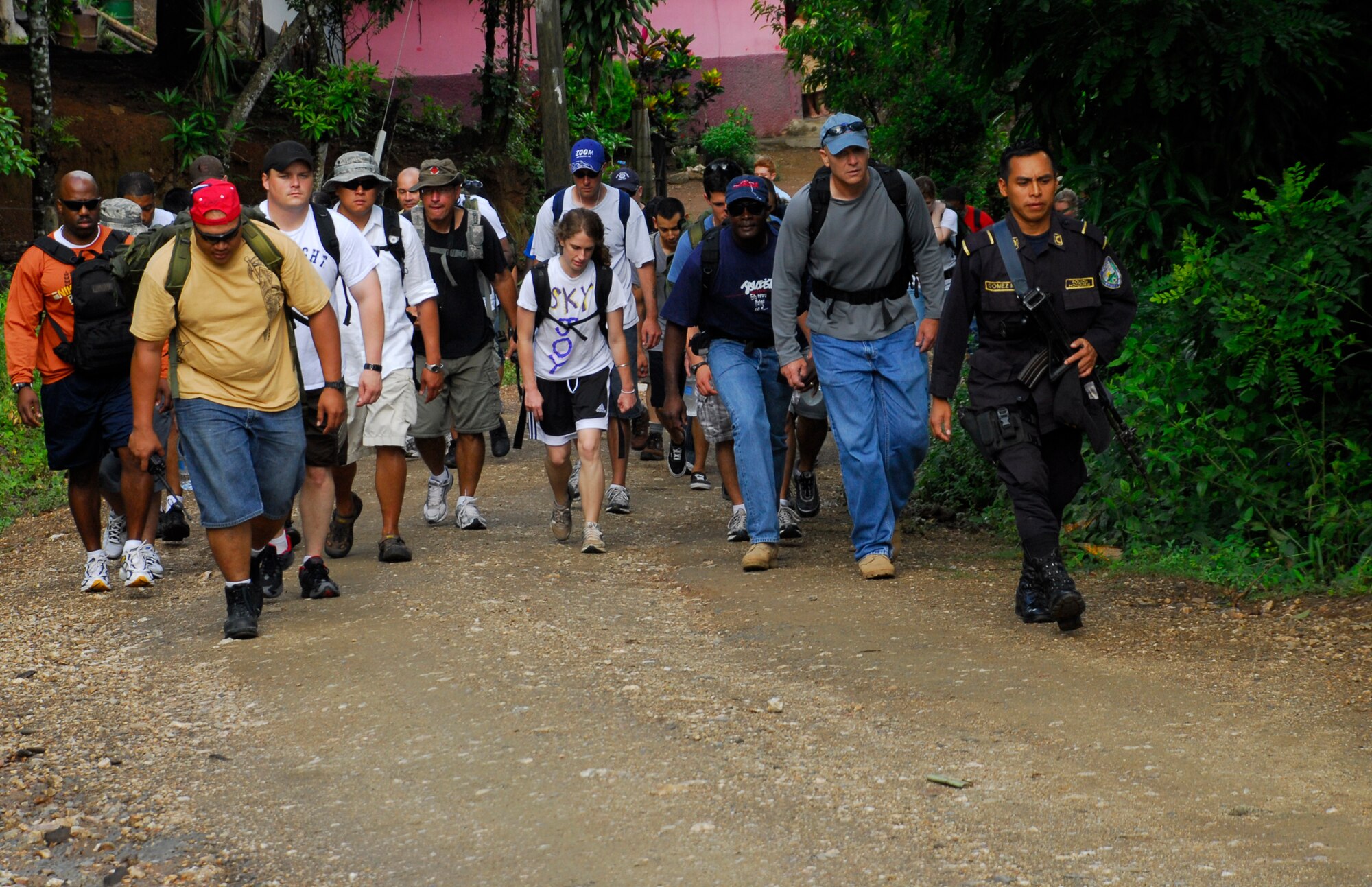 EL ROBLITO, Honduras --  After leaving the buses parked near a highway, members of Joint Task Force-Bravo hike up to this mountain village to deliver food, clothes and other supplies during a Chapel Hike here July 16. More than 50 JTF-Bravo members volunteered to trek up the mountain road to Escuela Juan Lindo to bring supplies to the villagers here. (U.S. Air Force photo/Tech. Sgt. Benjamin Rojek)