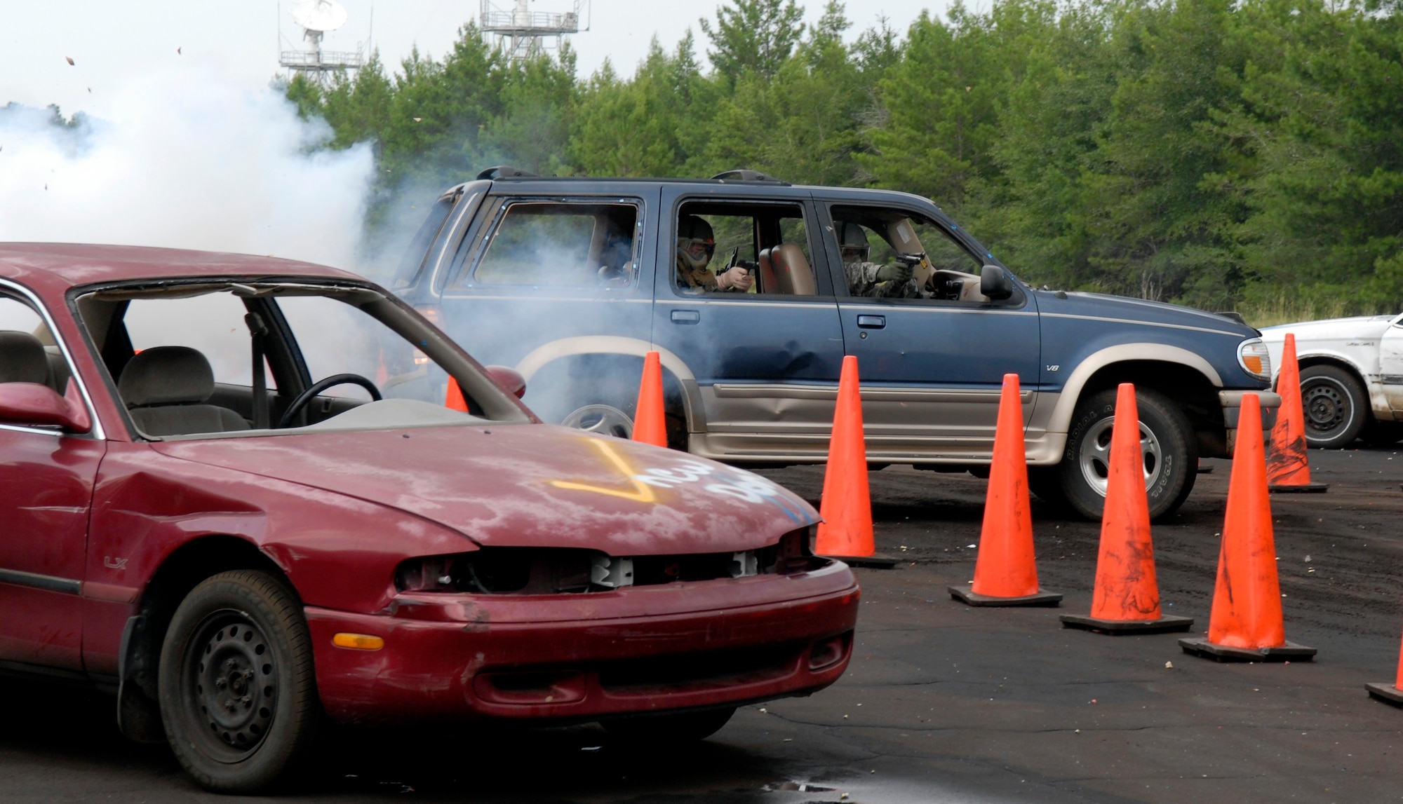 Students manuever through the driving course while undertaking smoke bombs and simulated rounds. The course is part of a defensive driving training exercise at Eglin Range, Fla., July 23, 2010. (DoD photo by U.S. Air Force Staff Sgt. Sarah Martinez)