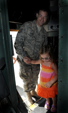 MOODY AIR FORCE BASE, Ga. -- Tech. Sgt. Kianta Asplund, 71st Aircraft Maintenance Unit aerospace propulsion technician, gives a tour of a HC-130P/N Combat King aircraft to his daughter, Mia, during Moody’s Bring Your Child to Work Day July 23. Sergeant Asplund showed his daughter what aircraft he works on daily. (U.S. Air Force photo/Airman 1st Class Benjamin Wiseman)
