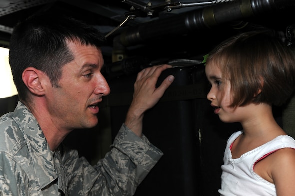 MOODY AIR FORCE BASE, Ga. -- Senior Master Sgt. Mathew Wells, 38th Rescue Squadron chief enlisted manager, speaks with his daughter Sophie inside an HH-60G Pave Hawk during Moody’s Bring Your Child to Work Day July 23. Military members were allowed to bring their family members to the base to see Moody static displays and other equipment. (U.S. Air Force photo/Airman 1st Class Benjamin Wiseman)