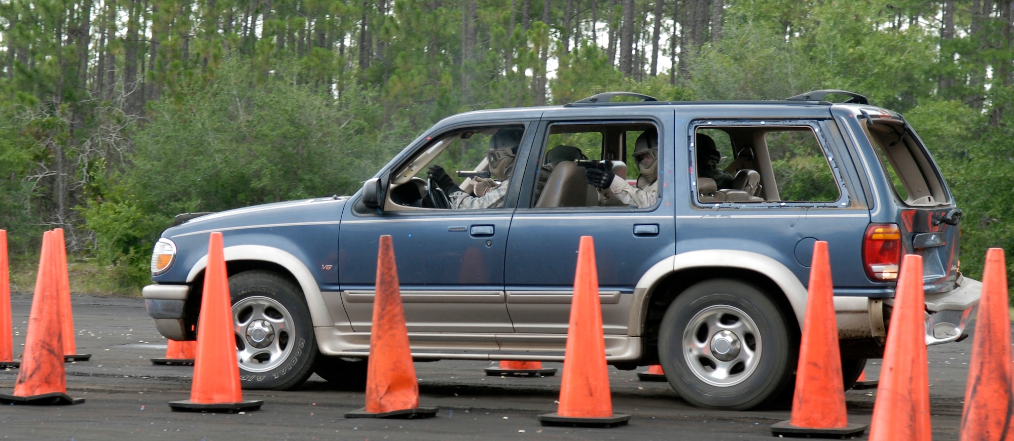 Students fire simulated rounds at the threat played by instructors, 1st Special Operations Support Squadron Range Support flight opposition forces members, while they drive through the training course. The training exercise took place at Eglin Range, Fla., July 23, 2010. (DoD photo by U.S. Air Force Staff Sgt. Sarah Martinez)