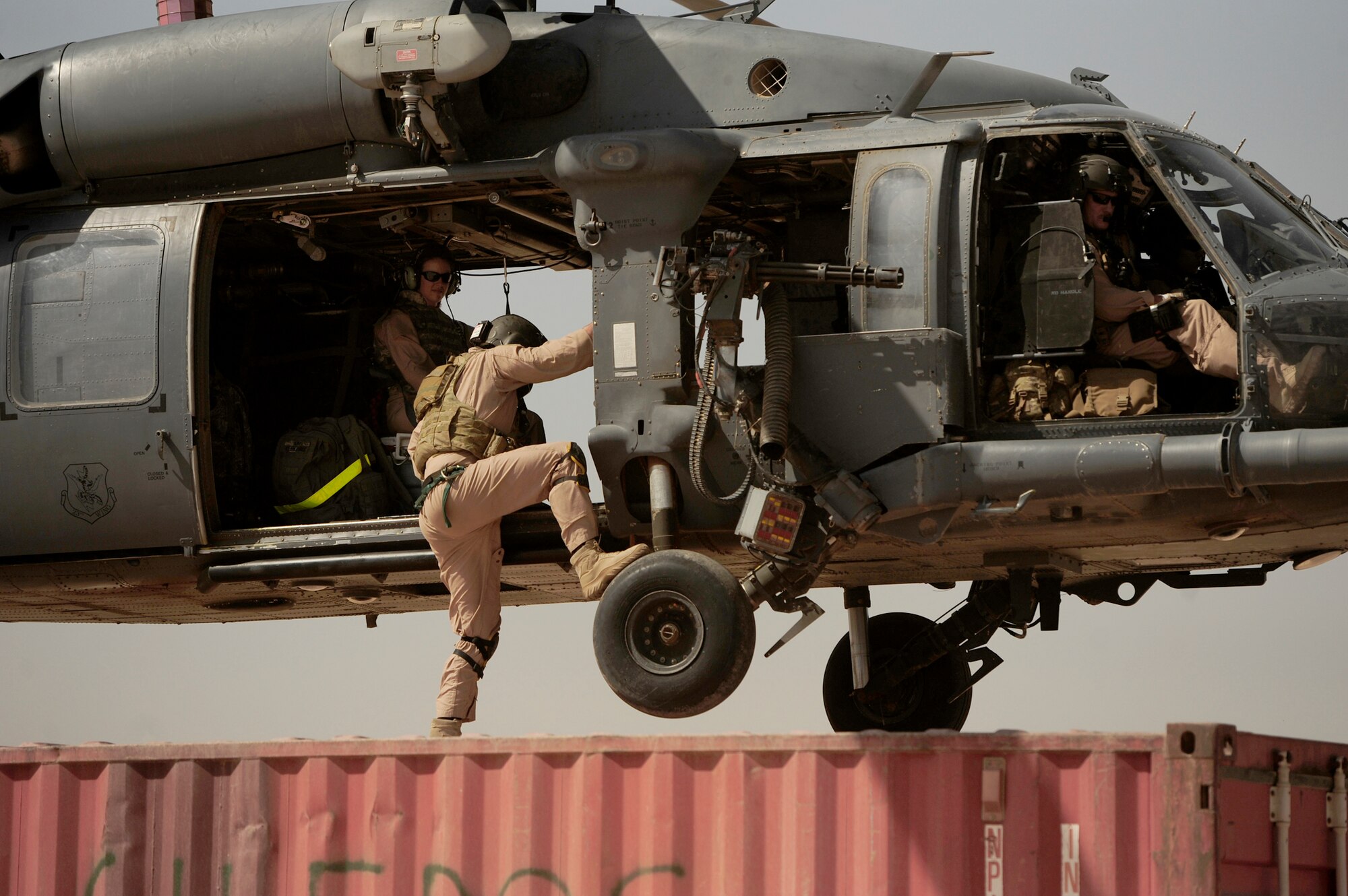Staff Sgt. Aaron Walton climbs into the helicopter before takeoff July 12, 2010, at Joint Base Balad, Iraq. Sergeant Walton is a flight engineer assigned to the 64th Expeditionary Rescue Squadron.  (U.S. Air Force photo/Staff Sgt. Andy M. Kin)