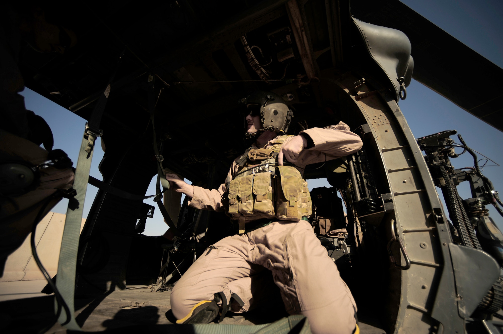 Staff Sgt. Aaron Walton locks his gunner's belt in place before a flying mission July 12, 2010, at Joint Base Balad, Iraq. Sergeant Walton is an HH-60G Pave Hawk flight engineer assigned to the 64th Expeditionary Rescue Squadron.  (U.S. Air Force photo/Staff Sgt. Andy M. Kin)