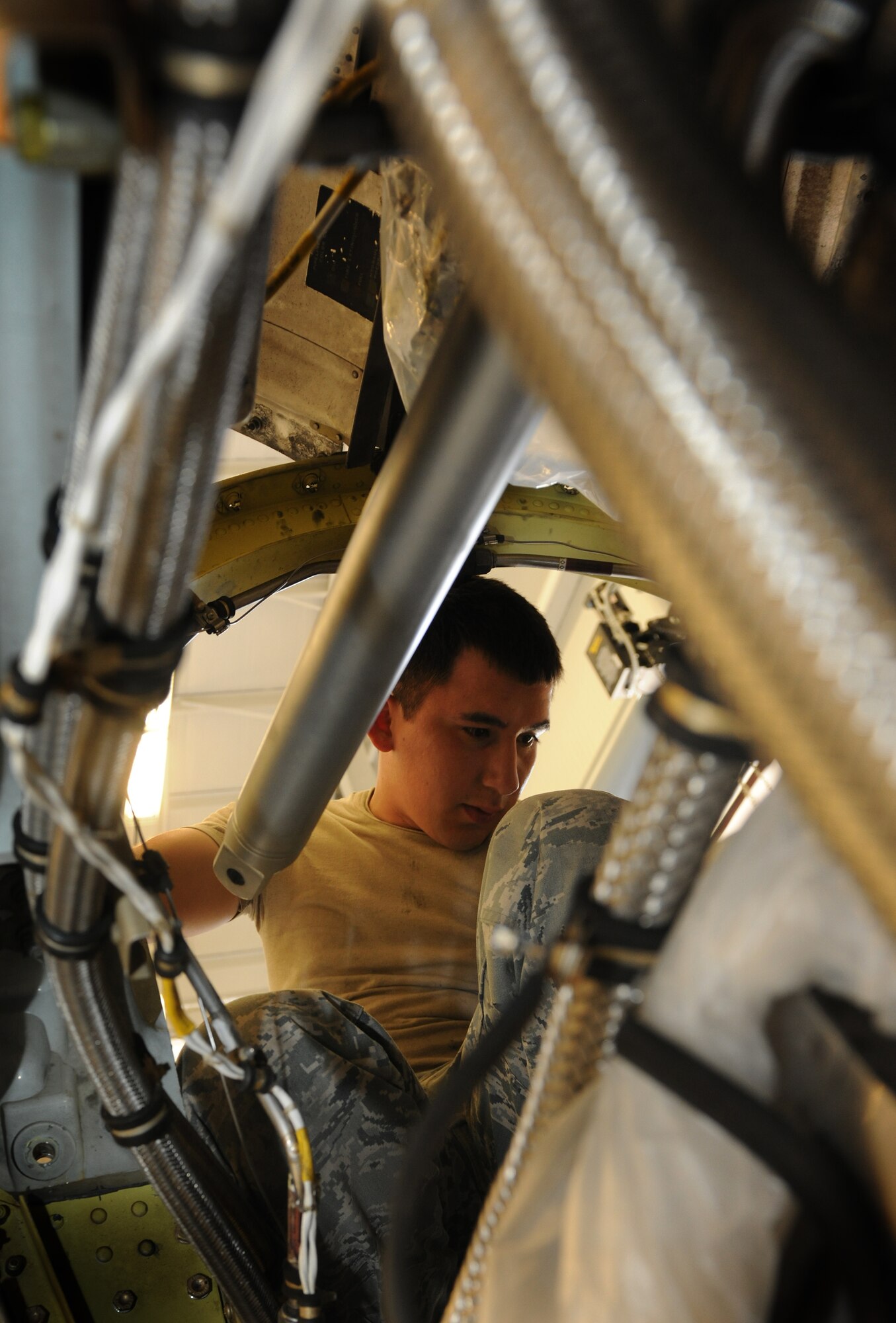 MOODY AIR FORCE BASE, Ga. -- Airman 1st Class Bobby Rodriguez, 23rd Component Maintenance Squadron aerospace propulsion apprentice, sits in the back of an engine from an HC-130P/N Combat King and prepares to install a reduction gearbox here July 22. Currently, Airman Rodriguez is qualified to repair only the HC-130P/N engine.   He will start training for the maintenance of other engines once he reaches his 5-level certification. (U.S. Air Force photo by Airman 1st Class Benjamin Wiseman/RELEASED)