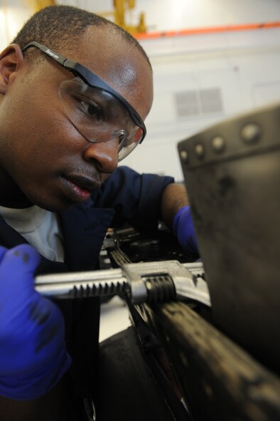 MOODY AIR FORCE BASE, Ga. -- Airman 1st Class Tavaris Brown, 23rd Component Maintenance Squadron aerospace propulsion apprentice, uses a set of pliers to remove safety wires from an A-10C Thunderbolt II pylon tower during maintenance on a TF-34 aircraft engine here July 22. Once the integration is completed, each aerospace propulsion technician from the base will be able to maintain the engines of the A-10C, HC-130 P/N Combat King and HH-60G Pave Hawk aircraft. (U.S. Air Force photo by Airman 1st Class Benjamin Wiseman/RELEASED)