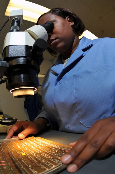 WHITEMAN AIR FORCE BASE, Mo. - Staff Sgt. Donnecha Blackmon, 509th Maintenance Group, Air Force Repair Enhancement Program lead circuit card repair technician, views a training circuit card through a microscope, July 21. Sergeant Stewart recently repaired an interface card for the 509th Maintenance Squadron resulting in uninterrupted avionics interface testing. (U.S. Air Force photo/Tech. Sgt. Charles D. Larkin Sr.)  (Released).                                            