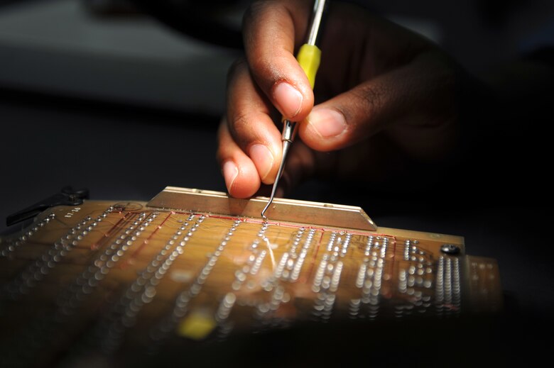WHITEMAN AIR FORCE BASE, Mo. - Staff Sgt. Donnecha Blackmon, 509th Maintenance Group, Air Force Repair Enhancement Program lead circuit card repair technician, practices repairs on a training circuit card, July 21. Sergeant Stewart recently repaired an interface card for the 509th Maintenance Squadron and saved the Air Force $370,000. (U.S. Air Force photo/Tech. Sgt. Charles D. Larkin Sr.)  (Released).                                            