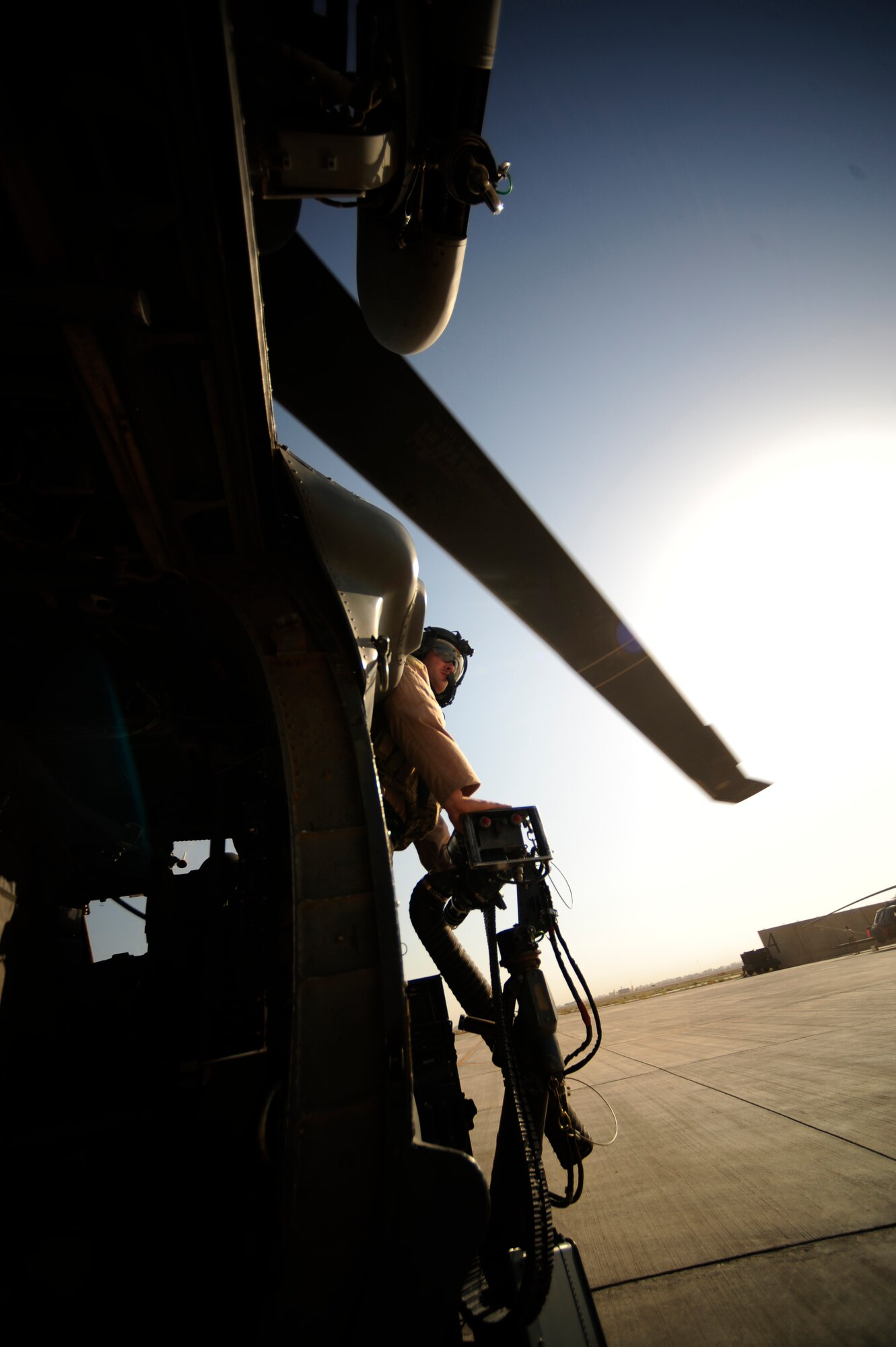 U.S. Air Force Staff Sgt. Aaron Walton, an HH-60G PaveHawk flight engineer assigned to the 64th Expeditionary Rescue Squadron, looks out for an all clear during take-off from Joint Base Balad, Iraq, July 12, 2010. (U.S. Air Force photo by Staff Sgt. Andy M. Kin / Released)
