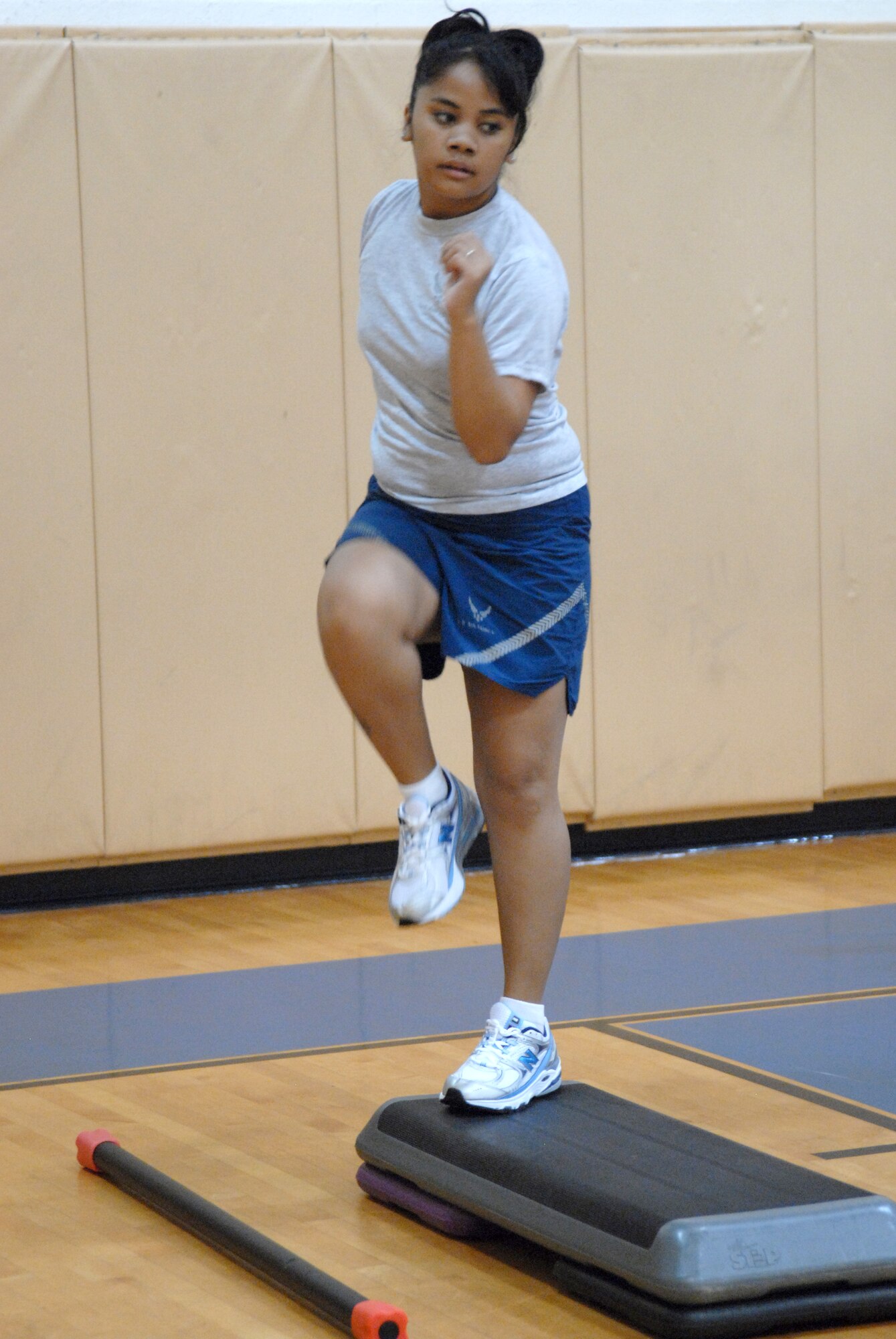 Senior Airman Fiatagata Ulukivaiola, 1st Special Operations Force Support Squadron, does high knee step aerobics during Post Pregnancy PT at the Commando Fitness Center, Hurlburt Field, Fla., July 21, 2010.  The class, sponsored by the Health and Wellness Center, is intended to help active-duty women recondition themselves and prevent injury by training members how to increase and maintain their fitness level properly after maternity leave. (U. S. Air Force photo by Staff Sgt. Orly N. Tyrell/Released)