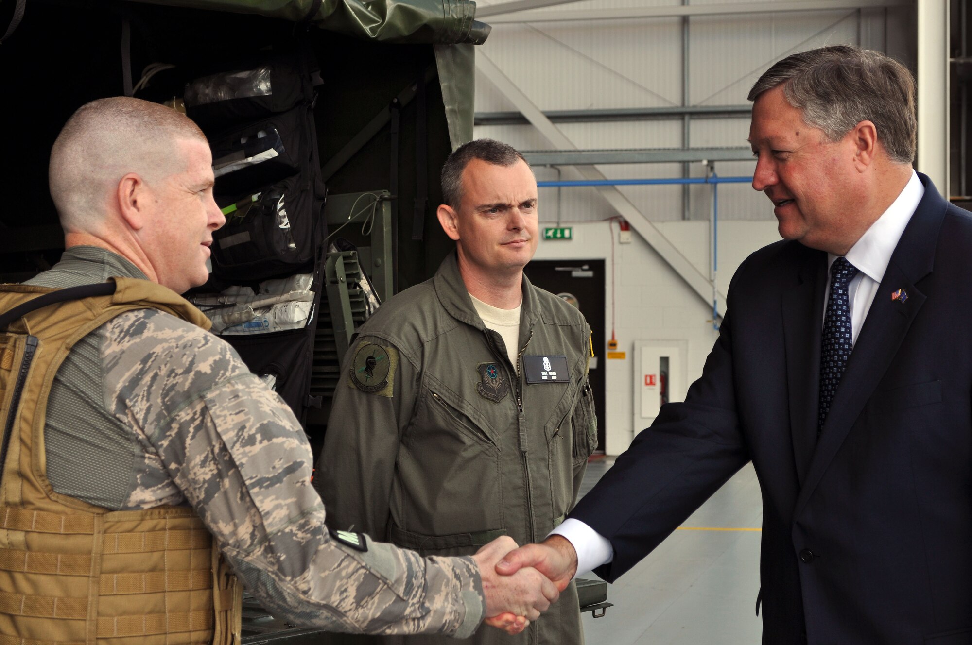 RAF MILDENHALL, England - Two Air Commando Independent Duty Medical Technicians for the 352nd Special Operations Group greet Secretary of the Air Force Michael Donley during his visit here.  While visiting the 352nd SOG, Secretary Donley was briefed on how the unit uses specialized air power to support United States strategic objectives, including direct support to Overseas Contingency Operations and joint/multinational exercises to build partner nation capacity.  (U. S. Air Force photo by Tech. Sgt. Marelise Wood)
