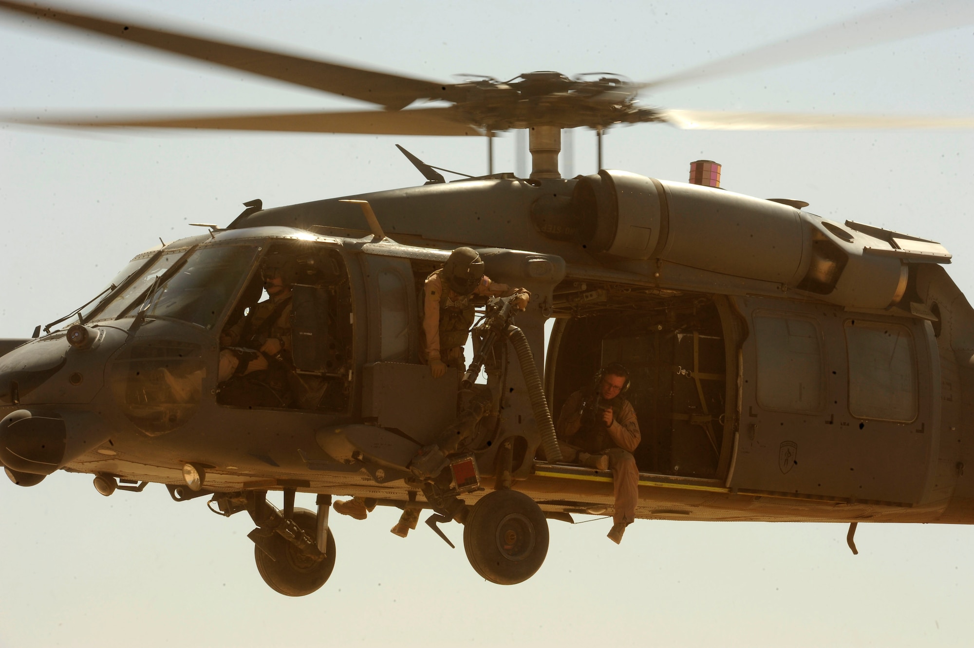 U.S. Air Force Technical Sgt. Justin Suddeth, a combat aerial videographer assigned to the 1st Combat Camera Squadron, documents the 64th Expeditionary Rescue Squadron aboard an HH-60G PaveHawk helicopter during a flying mission at Joint Base Balad, Iraq, July 12, 2010. (U.S. Air Force photo by Staff Sgt. Andy M. Kin / Released)