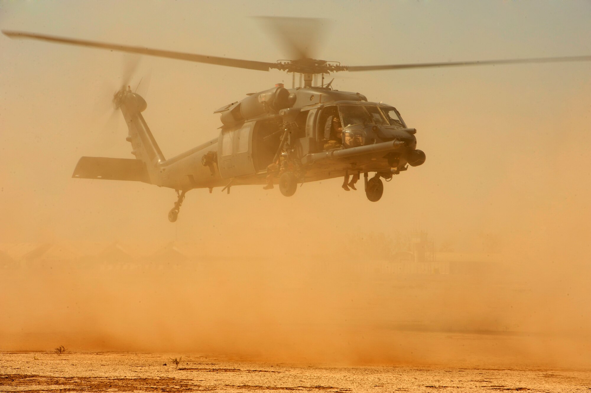 U.S. Air Force 1st Lt. Richard Scott, an HH-60G PaveHawk pilot assigned to the 64th Expeditionary Rescue Squadron, performs his approach in brown-out conditions onto a landing zone during a flying mission out of Joint Base Balad, Iraq, July 12, 2010. (U.S. Air Force photo by Staff Sgt. Andy M. Kin / Released)