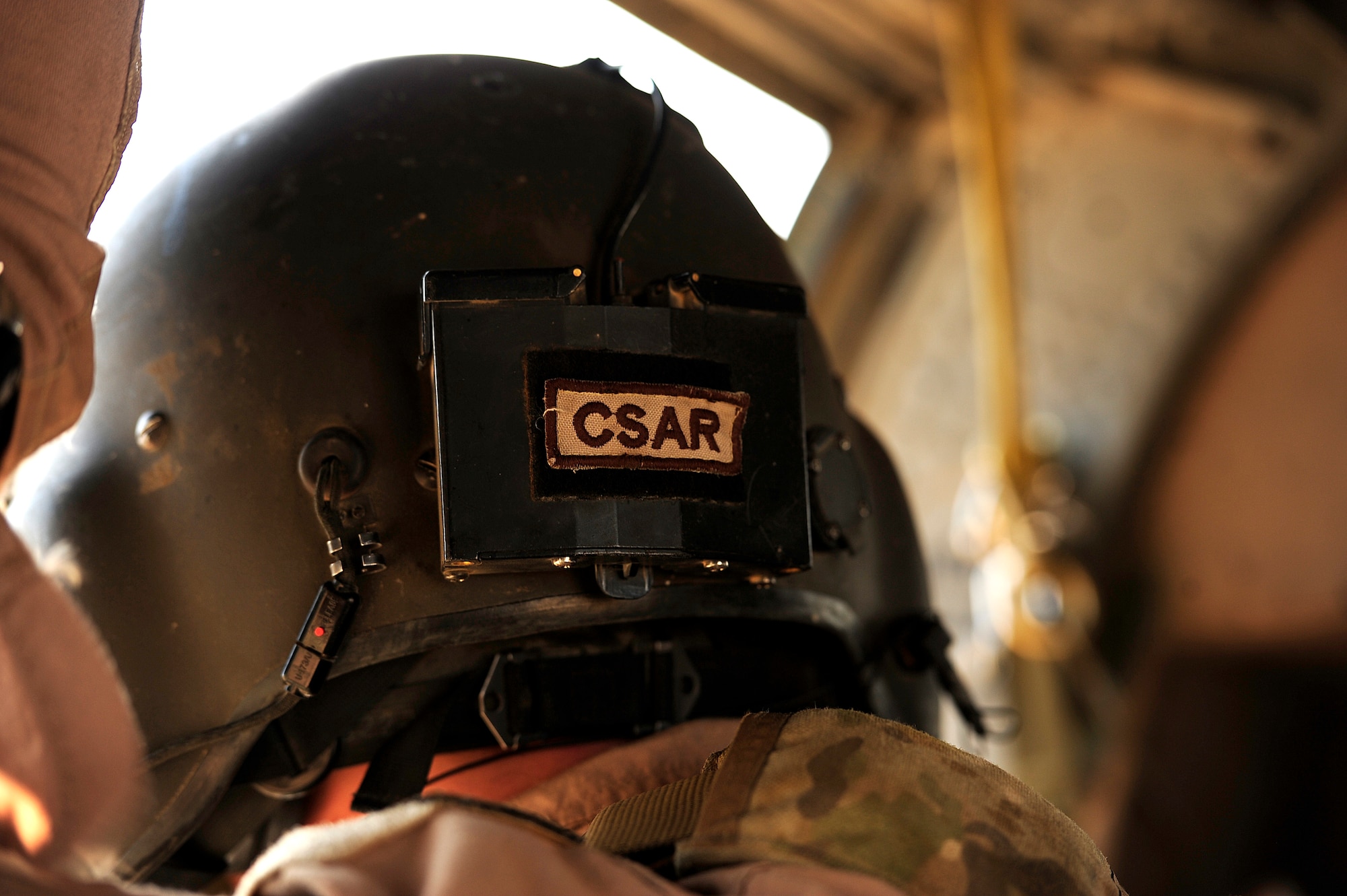 U.S. Air Force Staff Sgt. Andrew Pena, an HH-60G PaveHawk aerial gunner assigned to the 64th Expeditionary Rescue Squadron, wears his combat search and rescue tab(CSAR) on his helmet during a flying mission at Joint Base Balad, Iraq, July 12, 2010. (U.S. Air Force photo by Staff Sgt. Andy M. Kin / Released)