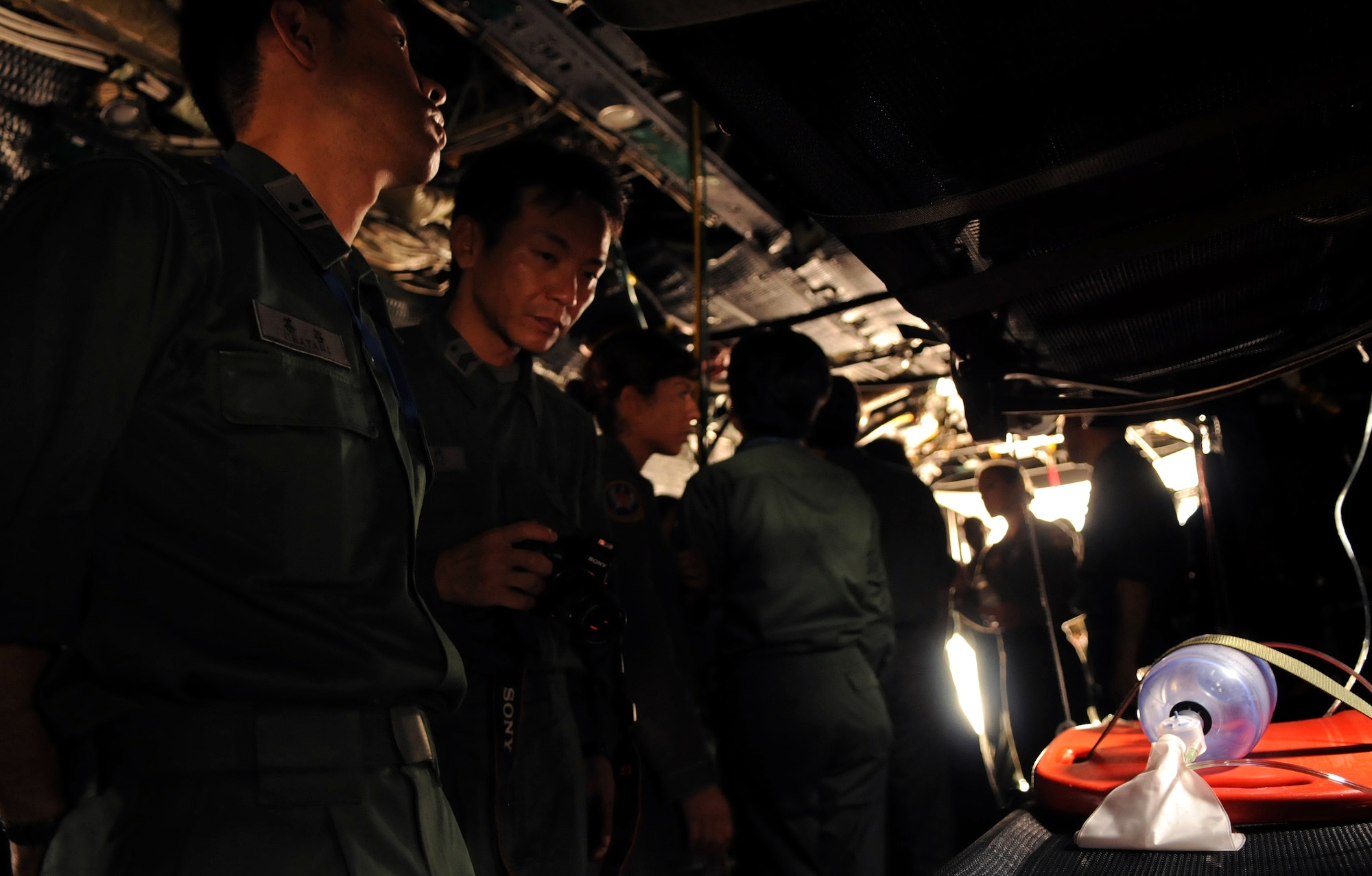 Japan Air Self Defense Force airmen look over equipment used by the 18th Aeromedical Evacuation Squadron during a bilateral aerovac exchange July 23. More than 30 JASDF airmen learned about the 18th AES mission and toured a C-130 and KC-135 configured for medical evacuations and neonatal care. (U.S. Air Force photo/Staff Sgt. Jason Lake)
