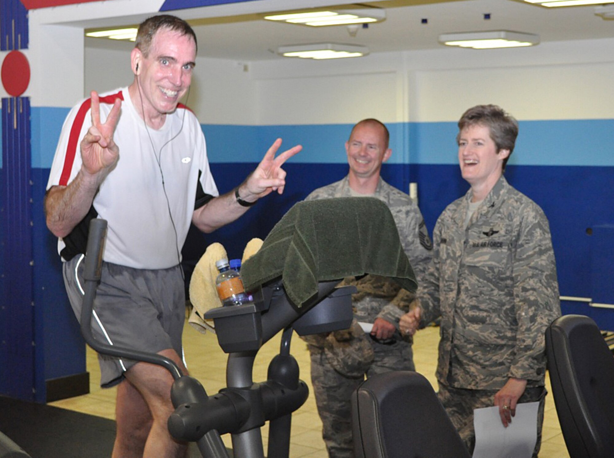 Col. Joseph Mastrianna, U.S. Air Forces in Europe Manpower, Personnel, and Services deputy director, stays positive during his five-hour elliptical marathon June 4, 2010. He "ran" a total of 12,500 miles on an elliptical machine to earn 1 million points for the Presidential Champion Platinum Award, which was presented July 22, 2010. (Courtesy photo)