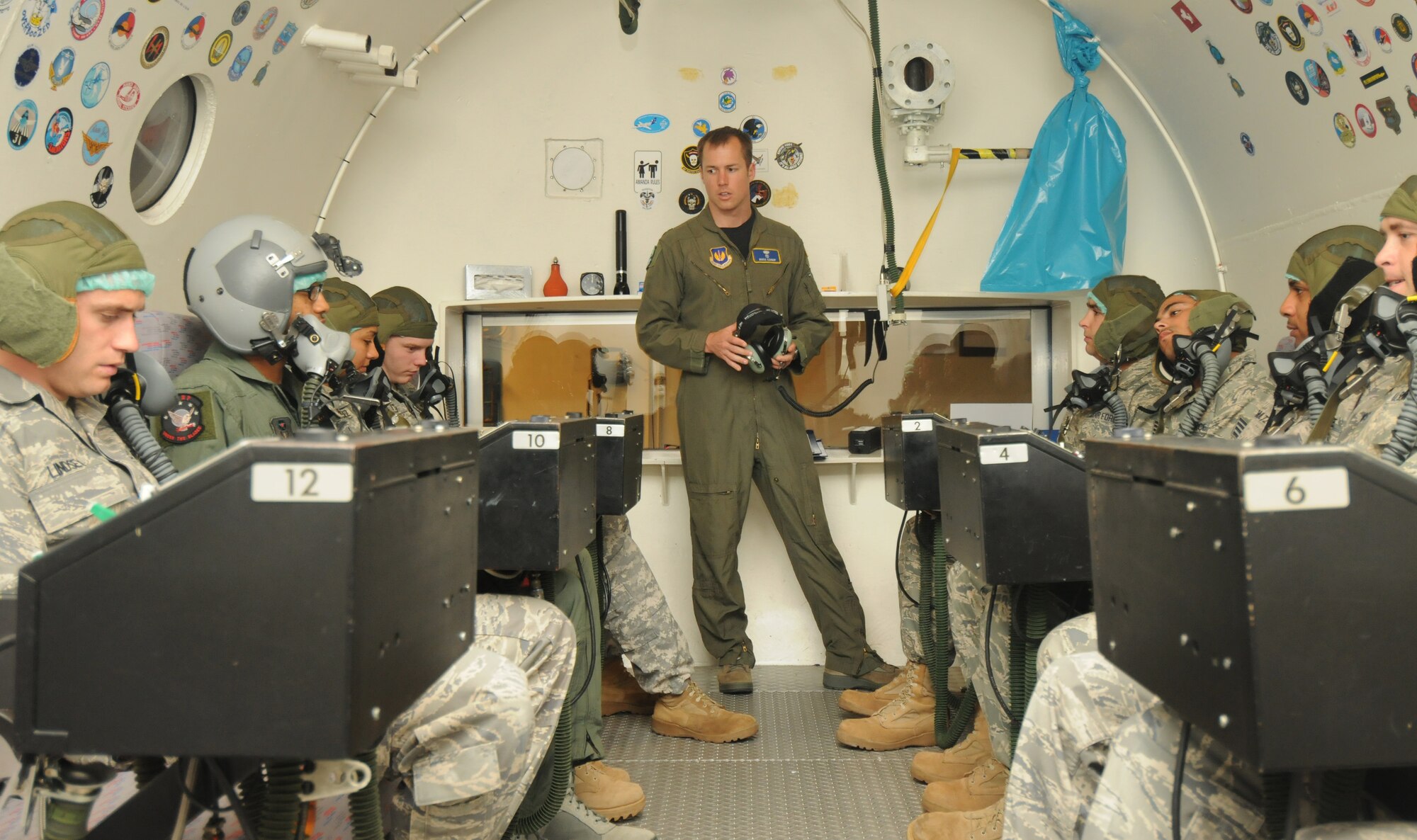 SOESTERBERG AIR BASE, Netherlands – Capt. Ross Canup, center, 86th Aerospace Medicine Squadron aerospace and operational physiology chief, Ramstein Air Base, briefs students in his class before they experience a pressure equivalent to an altitude of 25,000 feet June 24. The Royal Netherlands Center for Man and Aviation facility has been providing altitude chamber training in Europe for about 15 years. (U.S. Air Force photo/Staff Sgt. Benjamin Wilson)