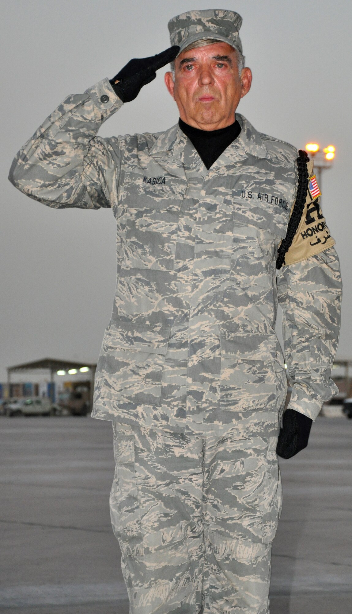 Senior Master Sgt. Paul Kasica, a member of the 447th Expeditionary Civil Engineering Squadron and the Base Honor Guard, salutes in honor of soldiers returning to Iraq as part of Operation Proper Exit.  Kasica, a New Jersey Air National Guardsman assigned to the 108th Air Refueling Wing, has been an Honor Guard volunteer for the past 19 years.  (U.S. Air Force photo by Tech. Sgt. Mike Edwards)