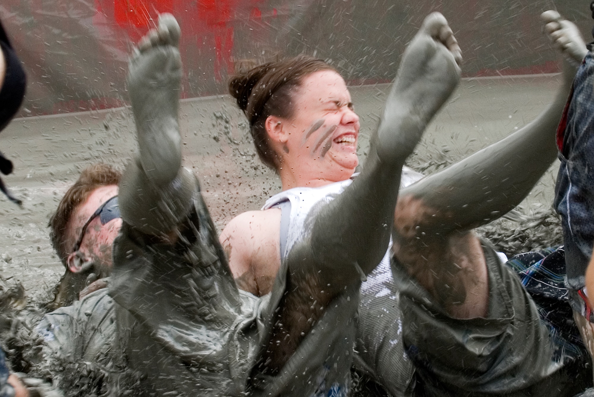 KUNSAN AIR BASE, Republic of Korea -- Two visitors to the South Korea Boryeong Mud Festival crash to the floor of the mud pit after sliding from one end to the other July 25. The festival, now in its 13th year, is one of the most popular tourist attractions in South Korea annually. (U.S. Air Force photo/Staff Sgt. Jonathan Pomeroy)