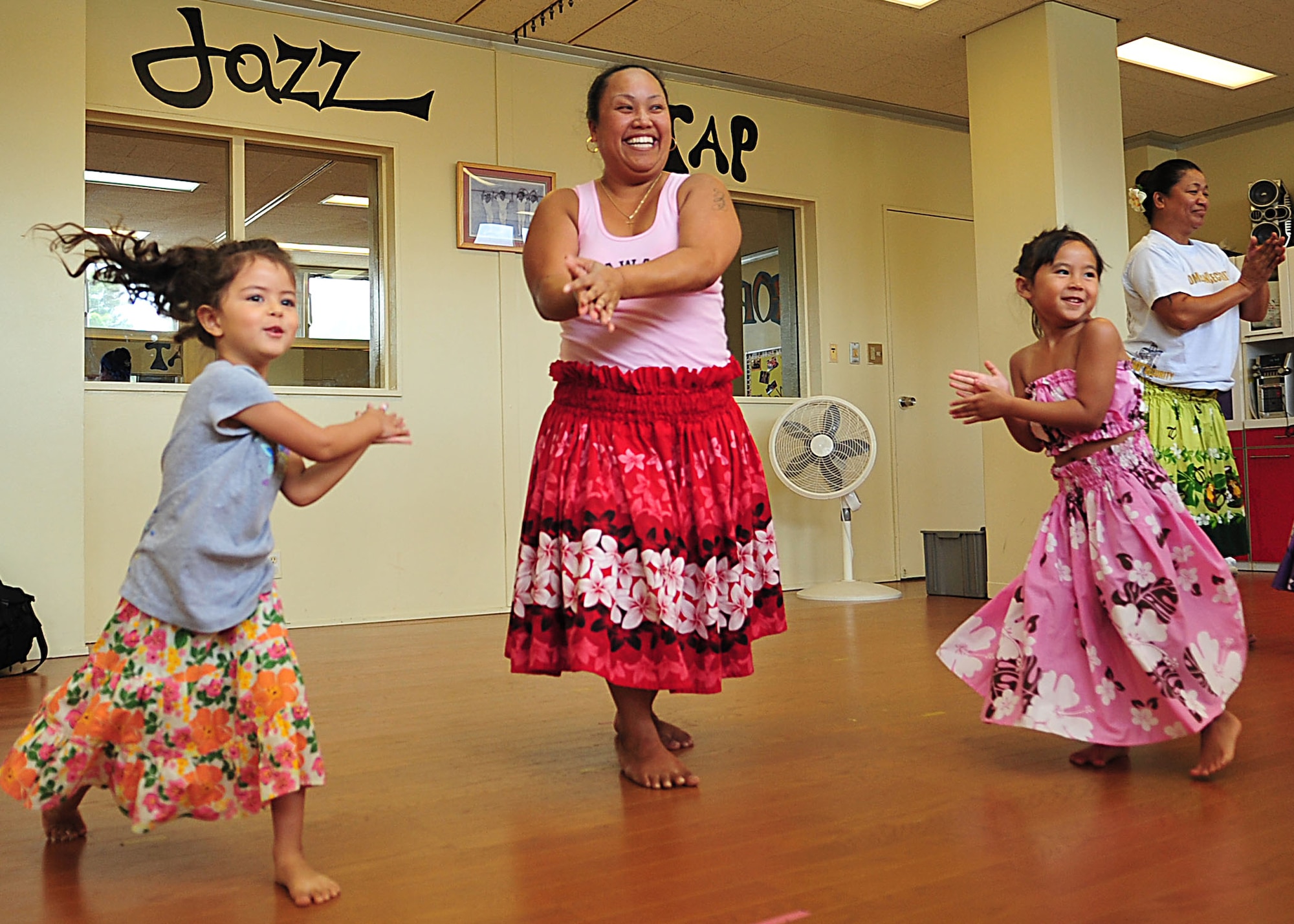 Zee Franklin teaches Silver Lachance (left) and Mila Cabradilla a Hawaiian dance during a dance class at the Kadena Air Base youth center July 25. The youth center offers many types of dance classes including jazz, tap and hip hop. (U.S. Air Force photo/Staff Sgt. Alesia Goosic) 
