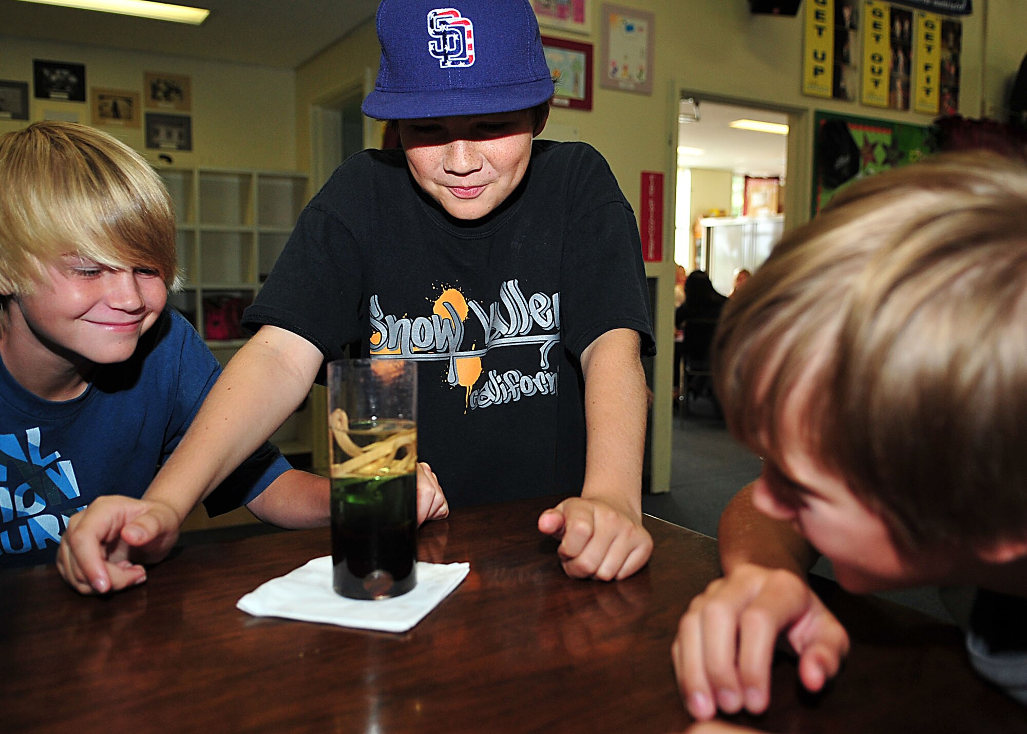 (From left to right) Reed Marshall, Thomas Focht and Devin Williams watch for the results of an experiment during the Immersion Learning science camp at the Kadena Air Base youth center July 25. Fifty children participated in the week-long summer camp. (U.S. Air Force photo/Staff Sgt. Alesia Goosic)