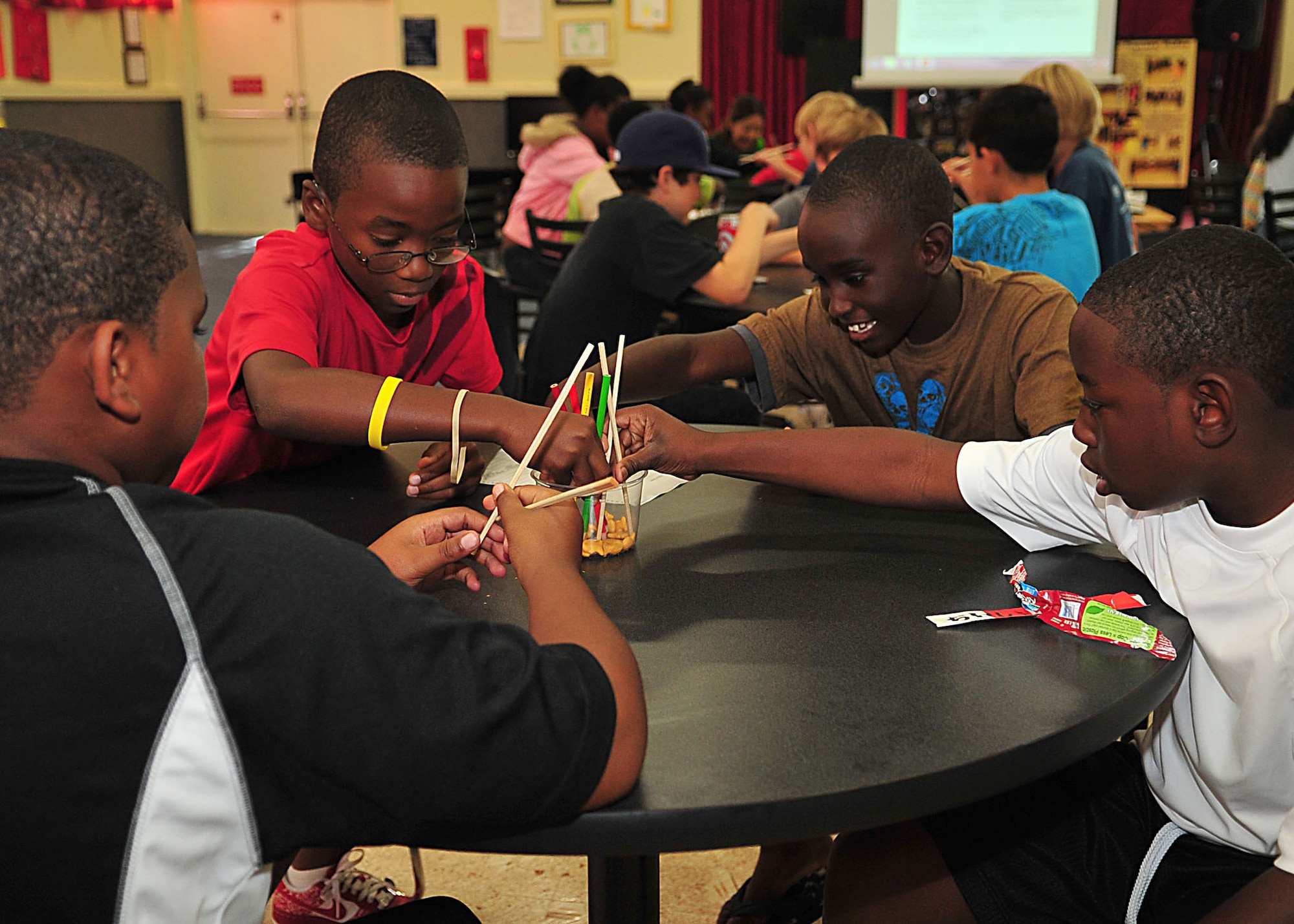 Children use chopsticks and pencils to simulate fishing during the Immersion Learning science camp at the Kadena Air Base youth center July 25. Immersion Learning was a week-long summer camp focused on underwater exploration. (U.S. Air Force photo/Staff Sgt. Alesia Goosic)