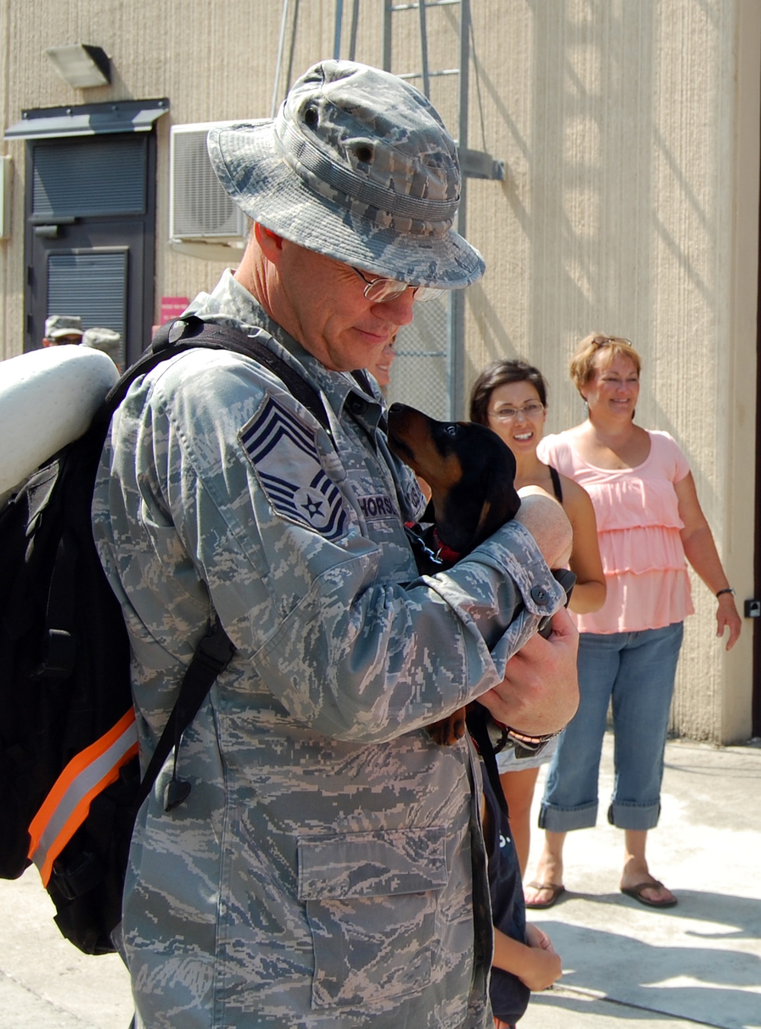 Chief Master Sgt. Virgil Horsley, 603rd Air Control Squadron, embraces his dog, Lily, after reuniting with his wife and son upon his return home to Aviano Air Base, Italy, July 23, 2010 from a six-month deployment to an unidisclosed location in Southwest Asia. More than 90 Airmen assigned to the 603rd ACS returned between July 12-23 from Kandahar, Afghanistan, and another undisclosed location downrange where they were conducting battle management of radio, radar and link support of Combined Forces Air Component commander objectives and supporting ground commander objectives by vectoring aircraft to troops in contact. (U.S. Air Force photo by Tech. Sgt. Lindsey Maurice/Released) 