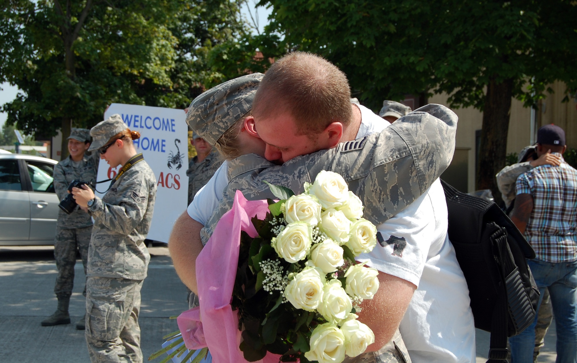 Keith O'Leary welcomes home his wife, Staff Sgt. Stephanie O'Leary, 603rd Air Control Squadron, upon her return home to Aviano Air Base, Italy, July 23, 2010 from a six-month deployment to an unidisclosed location in Southwest Asia. More than 90 Airmen assigned to the 603rd ACS returned between July 12-23 from Kandahar, Afghanistan, and another undisclosed location downrange where they were conducting battle management of radio, radar and link support of Combined Forces Air Component commander objectives and supporting ground commander objectives by vectoring aircraft to troops in contact. (U.S. Air Force photo by Tech. Sgt. Lindsey Maurice/Released) 