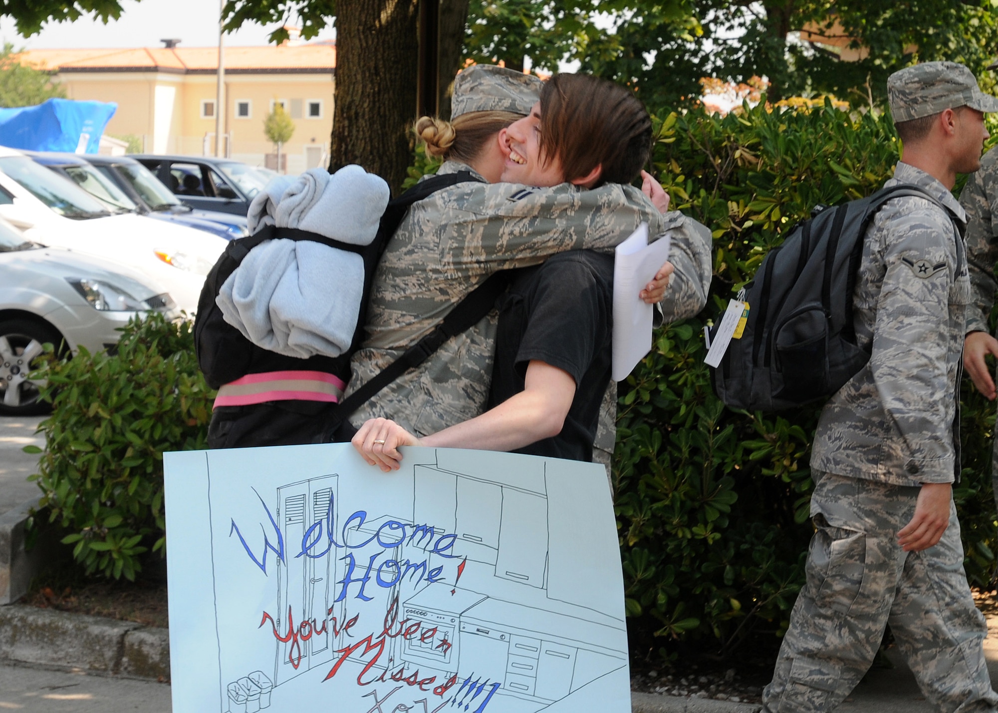 Michael Hunter welcomes home his wife, Airman 1st Class Jessica Hunter , 603rd Air Control Squadron, upon her return home to Aviano Air Base, Italy, July 23, 2010 from a six-month deployment to an unidisclosed location in Southwest Asia. More than 90 Airmen assigned to the 603rd ACS returned between July 12-23 from Kandahar, Afghanistan, and another undisclosed location downrange where they were conducting battle management of radio, radar and link support of Combined Forces Air Component commander objectives and supporting ground commander objectives by vectoring aircraft to troops in contact. (U.S. Air Force photo by Senior Airman Tabitha Lee/Released) 