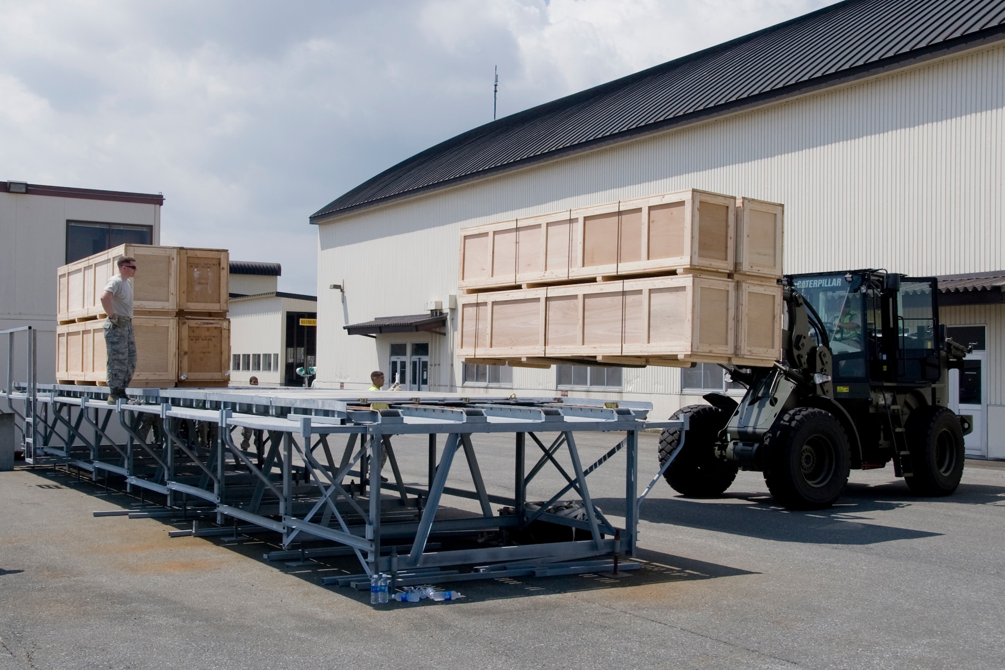 MISAWA AIR BASE, Japan -- Members of the 35th Logistics Readiness Squadron cargo deployment function prepare pallets for load July 21 outside of Hangar 949. The equipment will support the 13th Fighter Squadron and 35th Maintenance Group while deployed to Alaska for exercises Distant Frontier and Red Flag. (U.S. Air Force photo/Senior Airman Jamal D. Sutter)