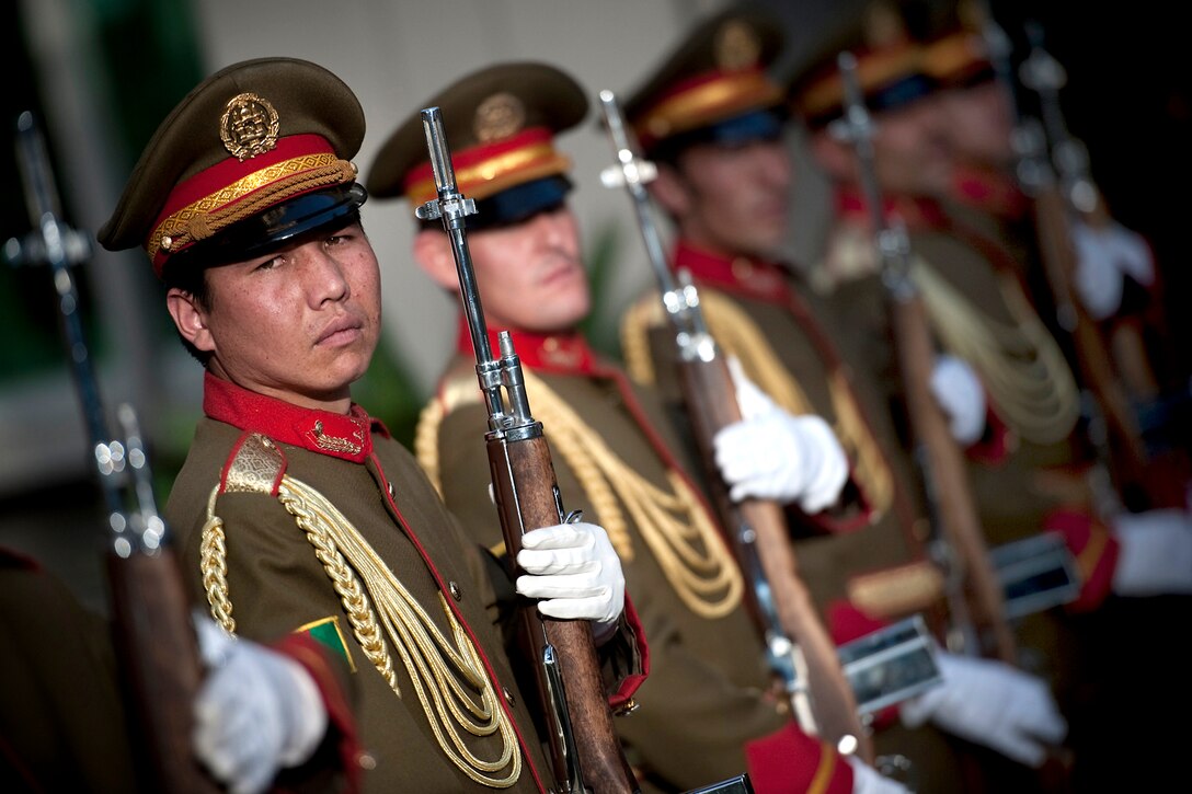Afghan Honor Guard soldiers conduct an honor cordon at the Ministry of Defense, welcoming U.S. Navy Adm. Mike Mullen, chairman of the Joint Chiefs of Staff, to Kabul, Afghanistan, July 25, 2010.