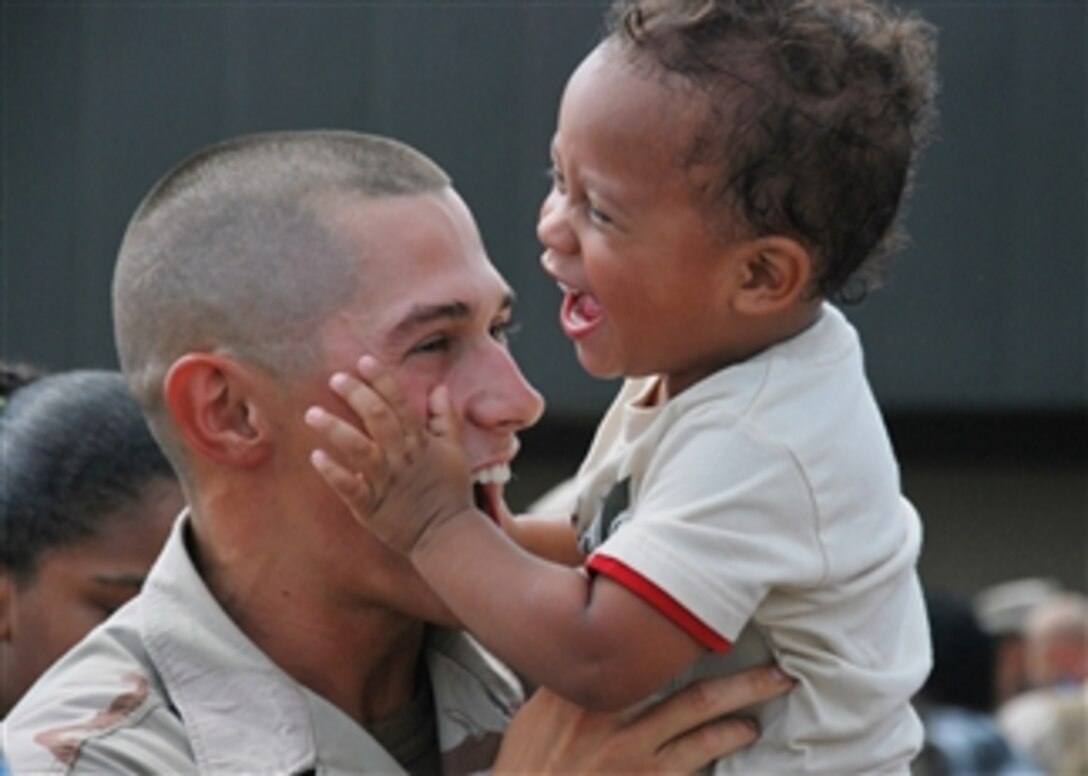 A U.S. Navy sailor assigned to Naval Mobile Construction Battalion 133 greets his son during a homecoming ceremony for the unit in Gulfport, Miss., on July 21, 2010.  Naval Mobile Construction Battalion 133 returned from a five-month deployment to the U.S. Central Command area of responsibility in support of Operation Enduring Freedom.  
