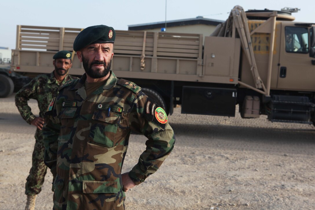 Lt. Col. Amanullah, commanding officer, 5th Kandak, 1st Brigade, 215th Corps, partnered with Combat Logistics Battalion 5, Embedded Partnering Team, 1st Marine Logistics Group (Forward), watches as his troops prepare for a combat logistics patrol at Camp Leatherneck, Afghanistan, July 26. The CLB-5 EPT trains and mentors soldiers of the Afghan National Army to provide logistical capabilities in support of the International Security Assistance Force.