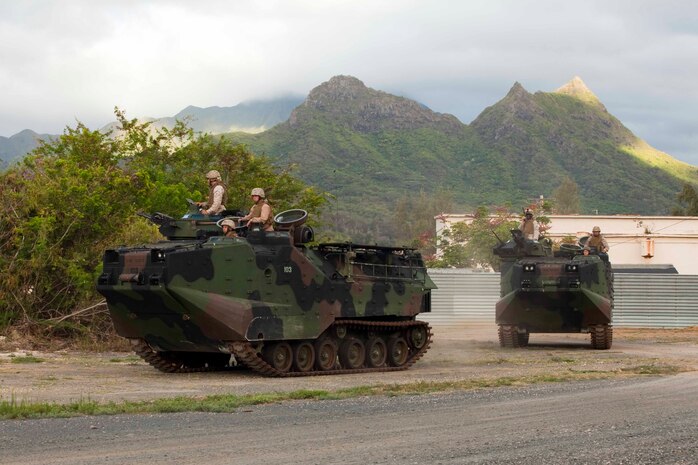 U.S. Marines assigned to 3rd Marine Regiment utilize amphibious assault vehicles to set up a cordon around a mock U.S. embassy during a noncombatant evacuation operation at Marine Corps Training Area Bellows, Hawaii, July 26. The NEO, an emergency evacuation involving the use of military forces and capabilities in order to provide aid, assistance and movement to safety of American citizens overseas, was conducted as part of interoperability training between coalition forces during the multi-national Exercise Rim of the Pacific 2010.
